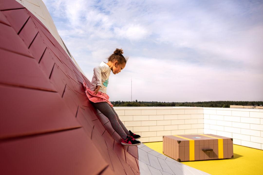 Girl sliding down playground structure