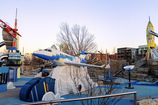 Wooden playground airplanes and rocket at adventure playscape at science center