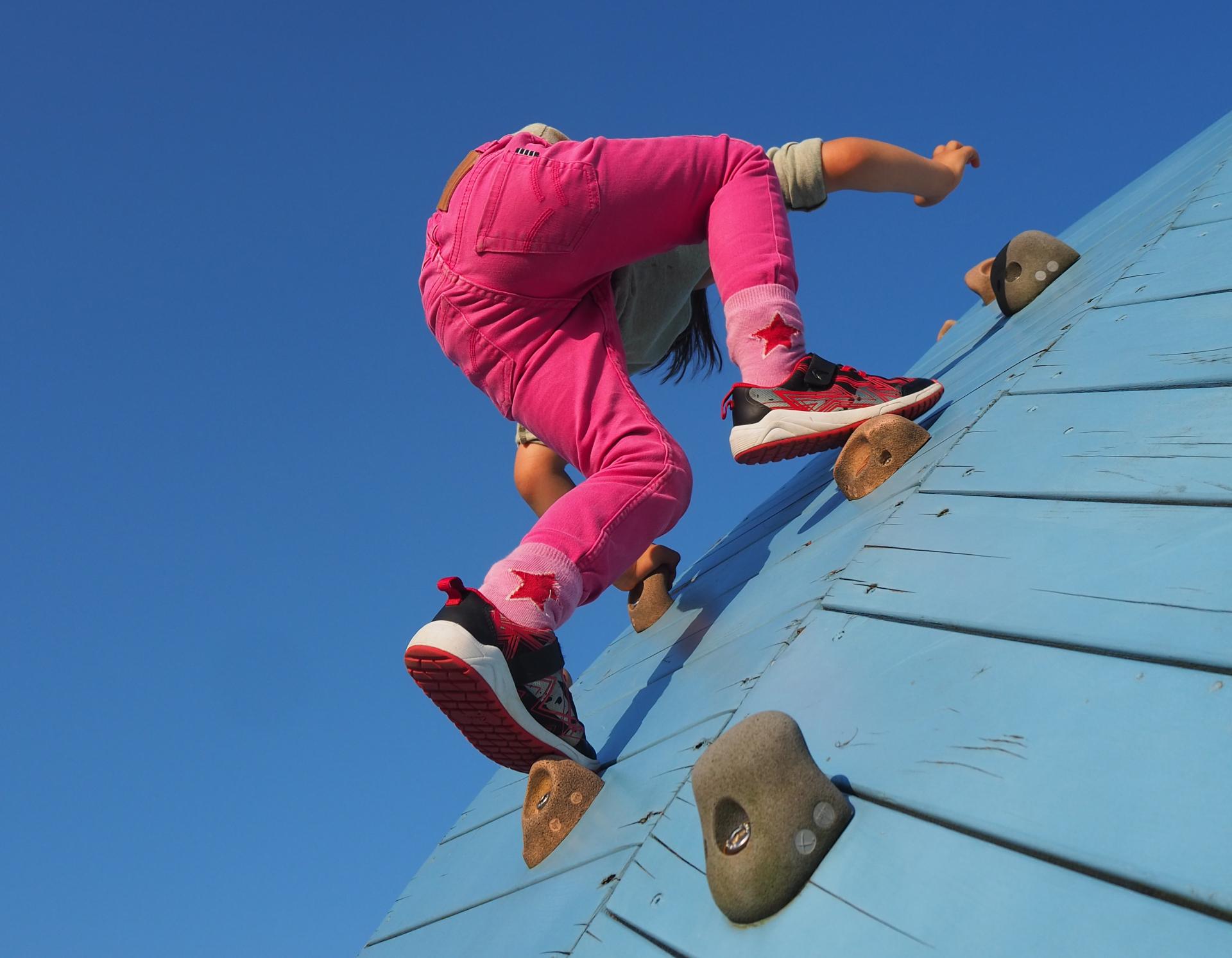 Boy climbing play structure, MONSTRUM Playgrounds
