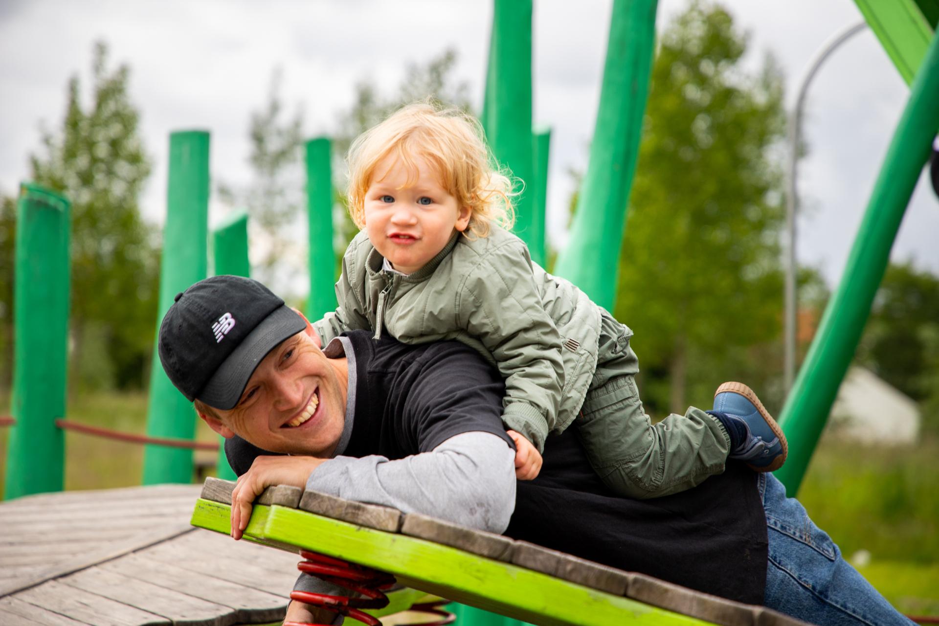 Dad & boy playing at playground