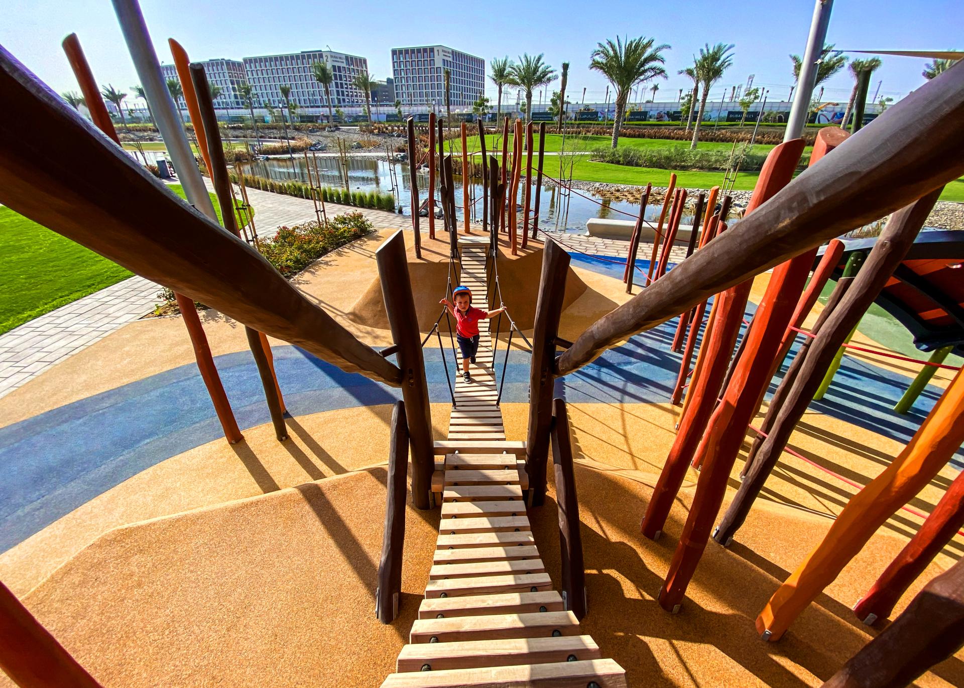 Suspension bridge from the tower to the little island MONSTRUM playgrounds dragon dubai hills park
