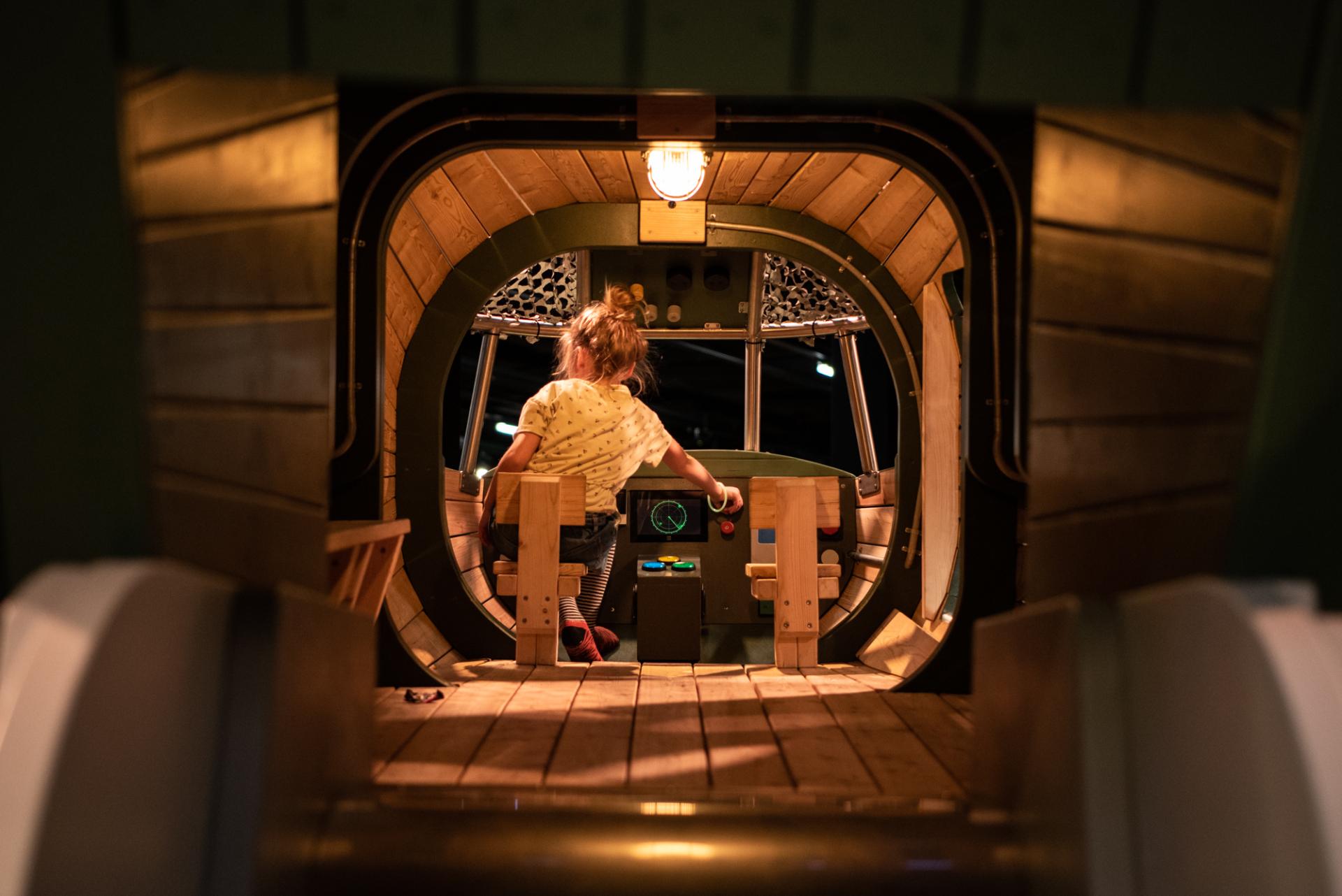 Girl playing inside helicopter play structure