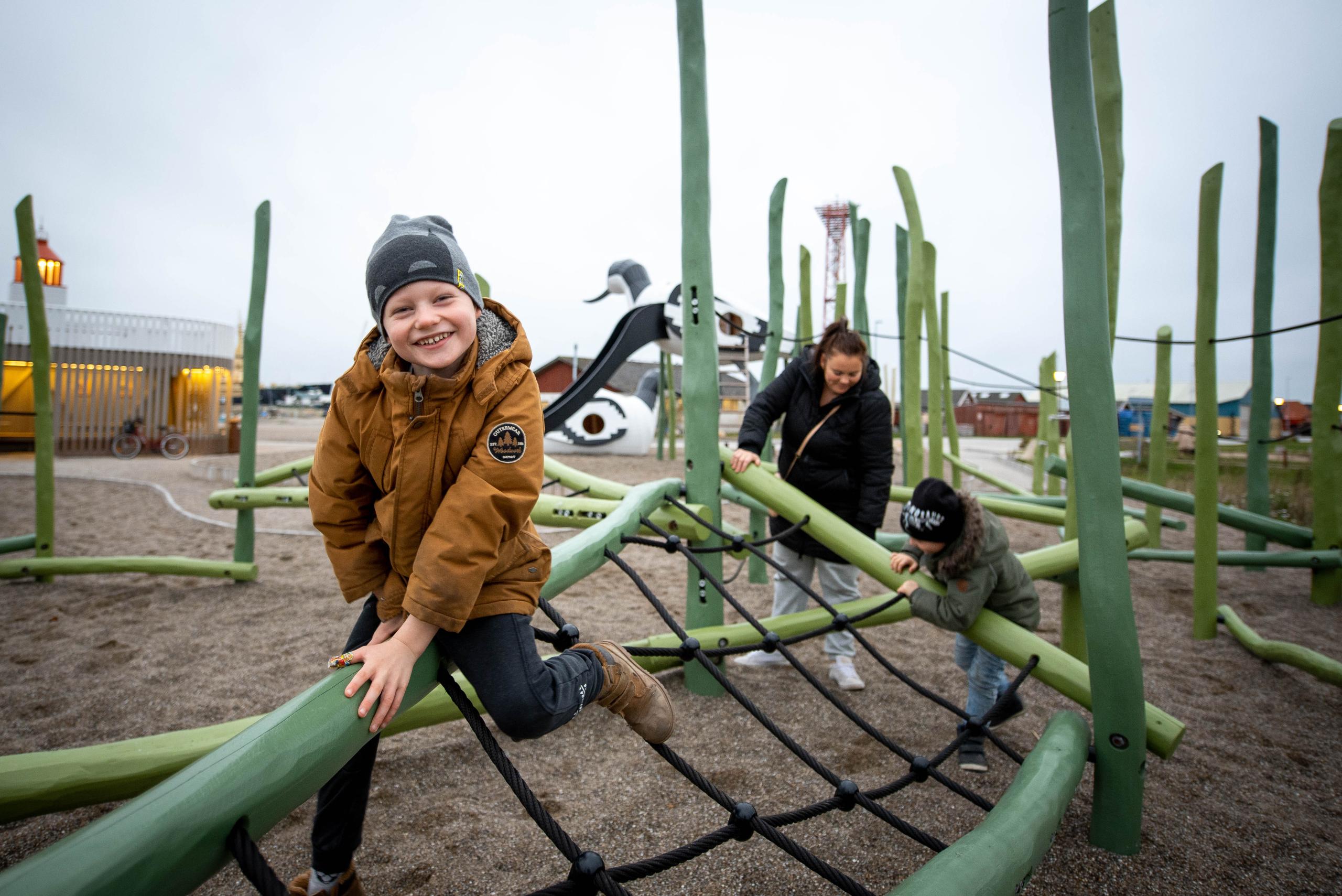 Kids climbing on play structure having fun at playground