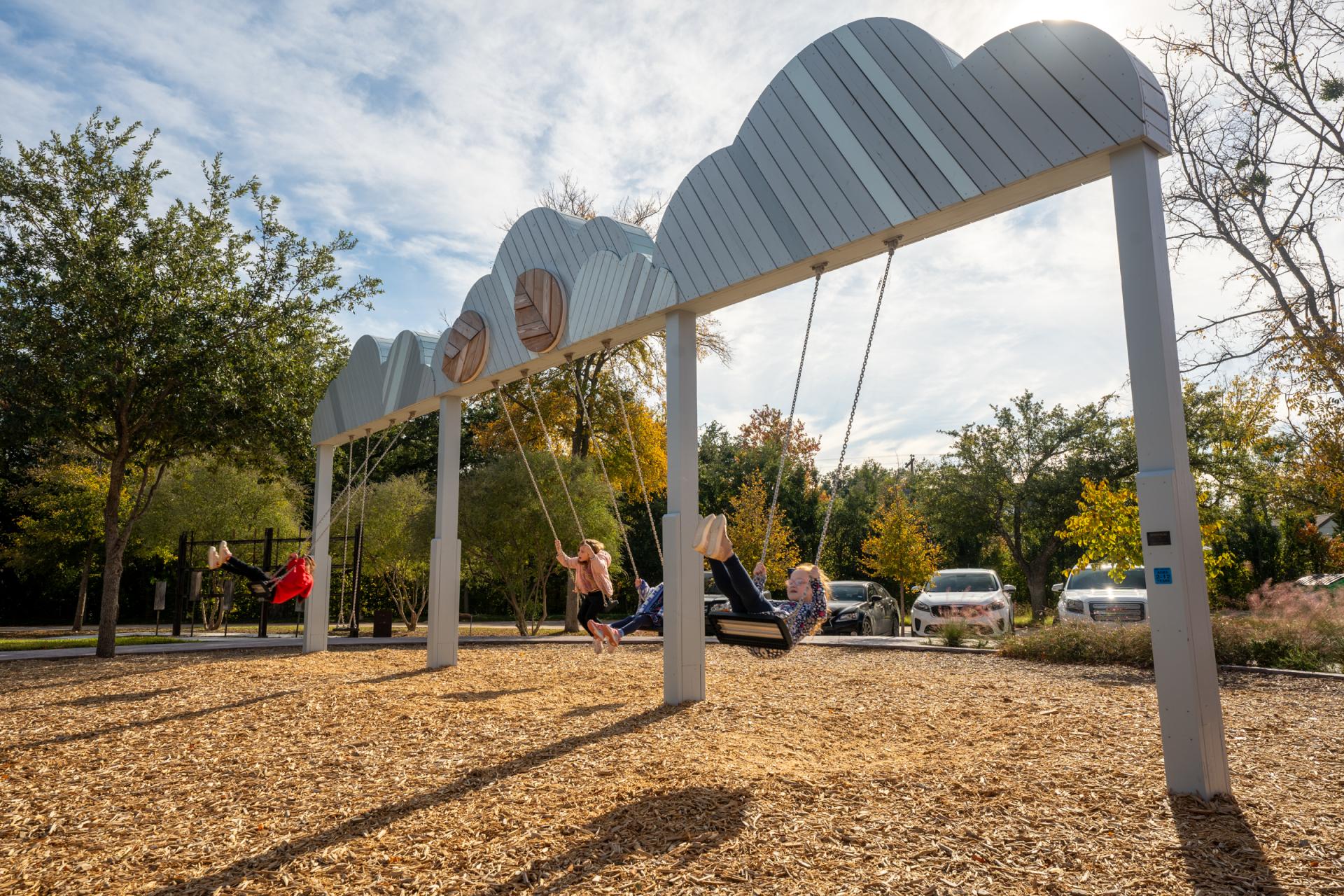 Kids swinging on cloud swing at playground