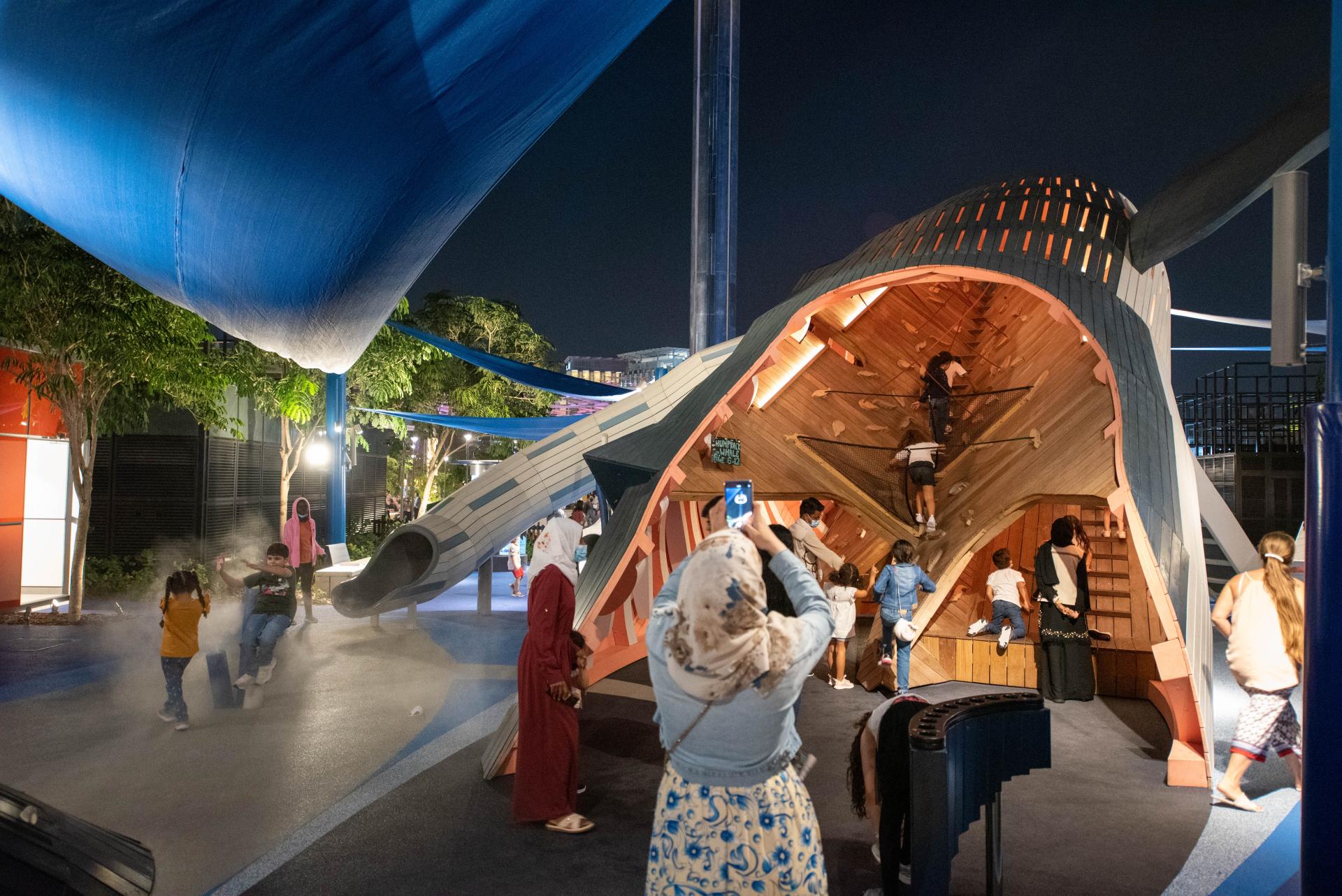 Whale playground, mum taking photo of kids playing, MONSTRUM playgrounds Expo 2020