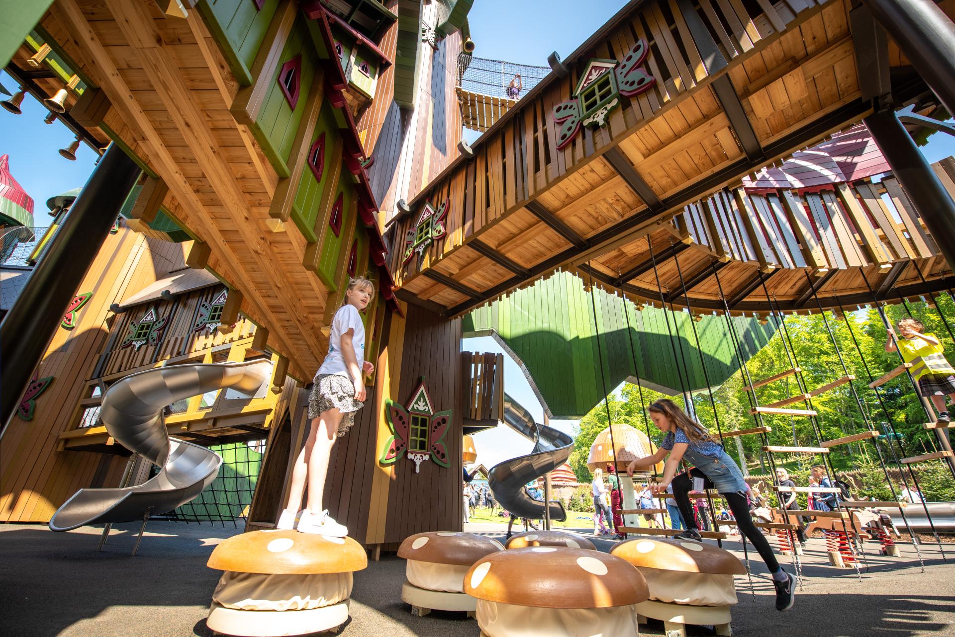 Kids jumping on musical mushrooms at Lilidorei playground