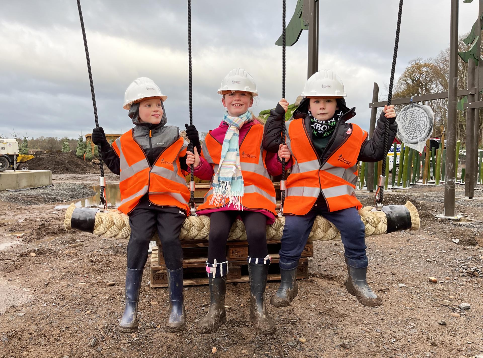 Primary school kids visiting Lilidorei playground and trying the swing