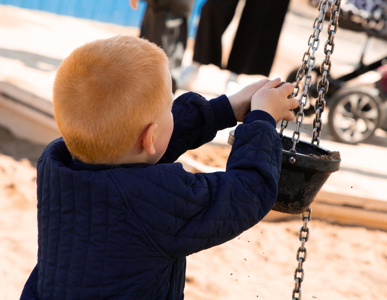 Boy playing with sand at playground