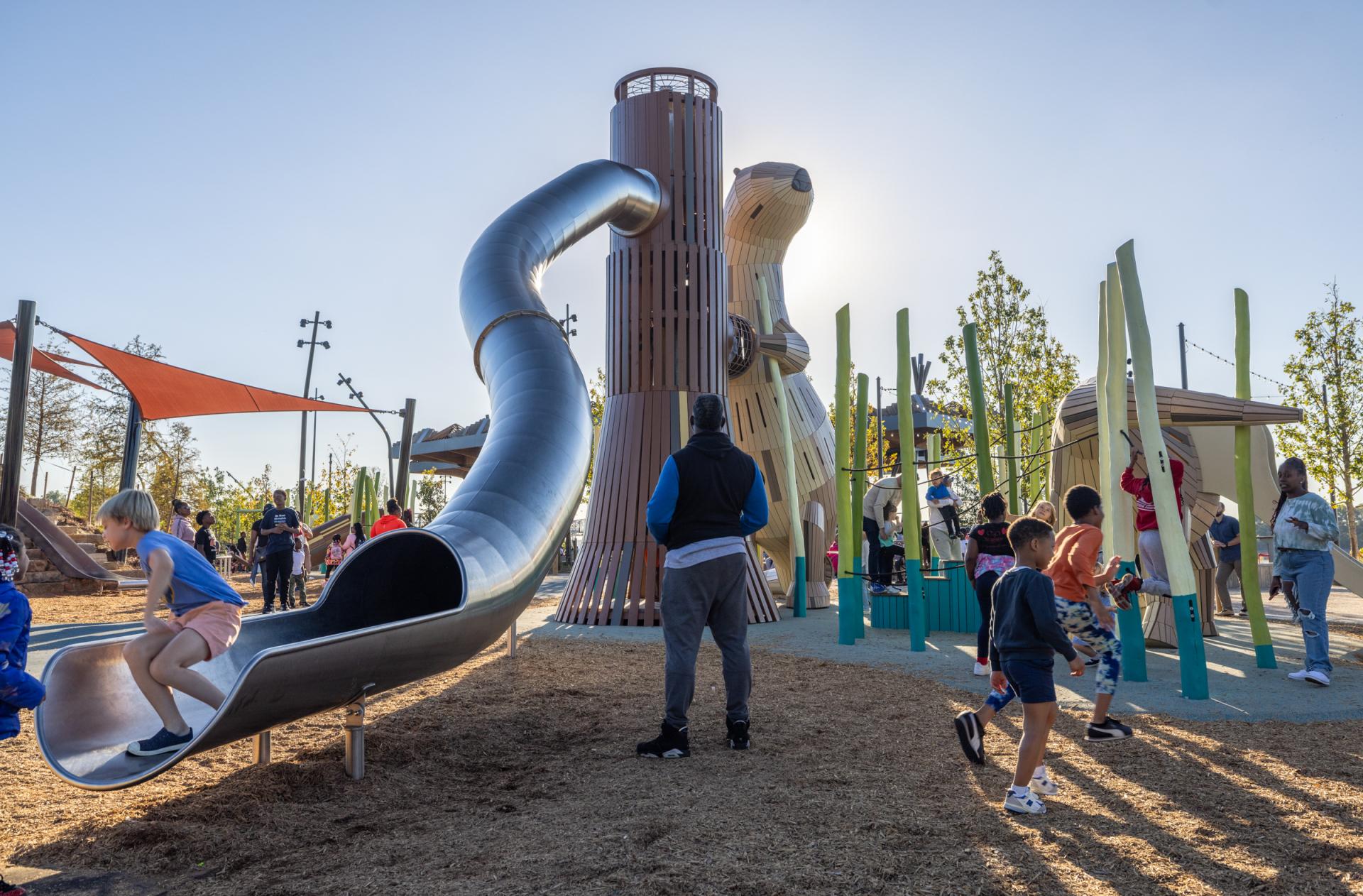 Kids playing on big otter playground structures