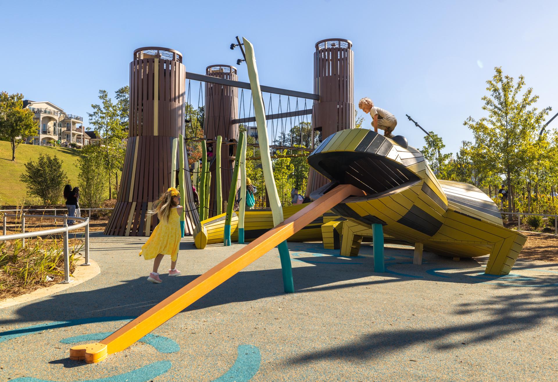 Kids playing on salamander playground structure