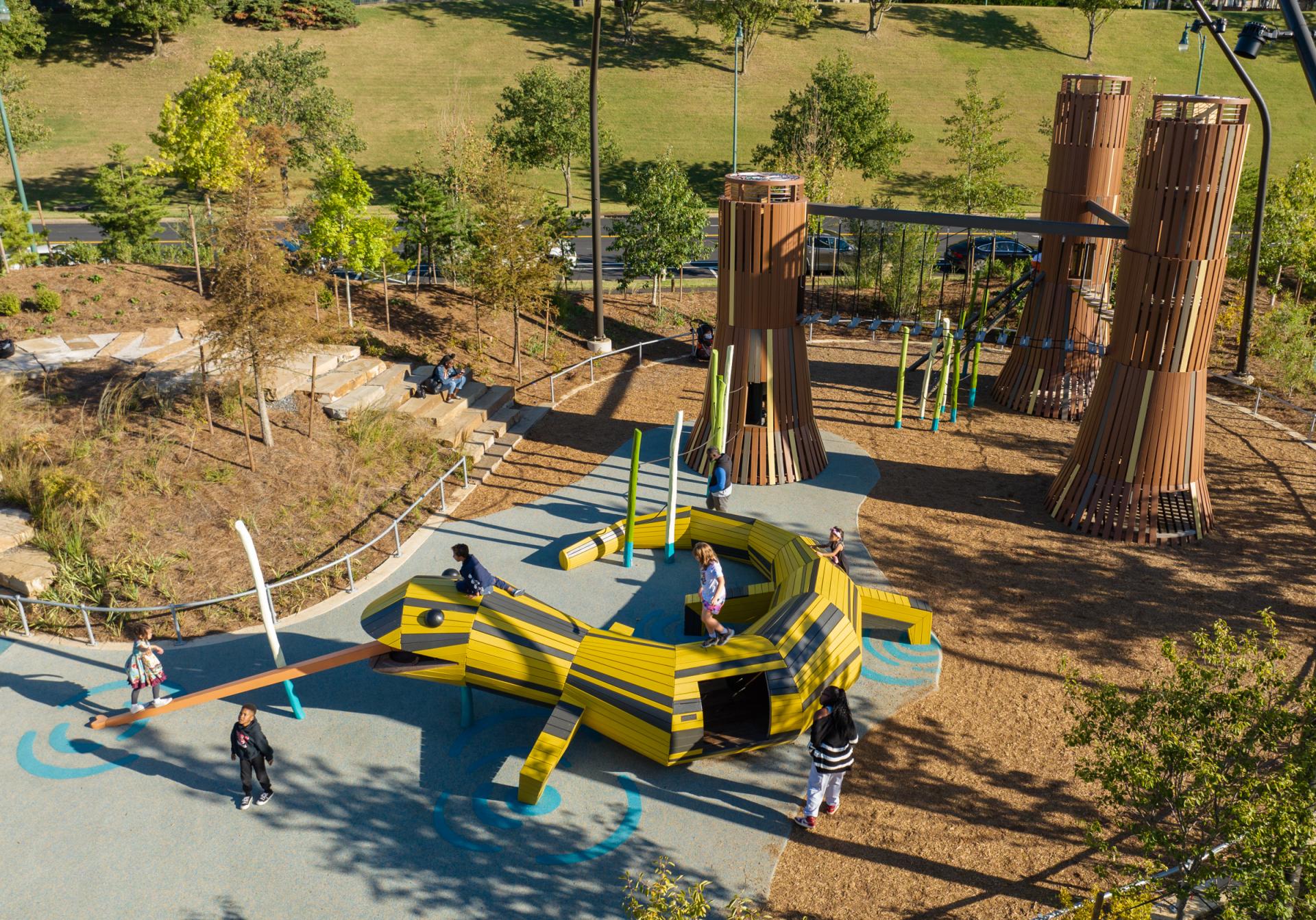 Kids playing on salamander playground structure