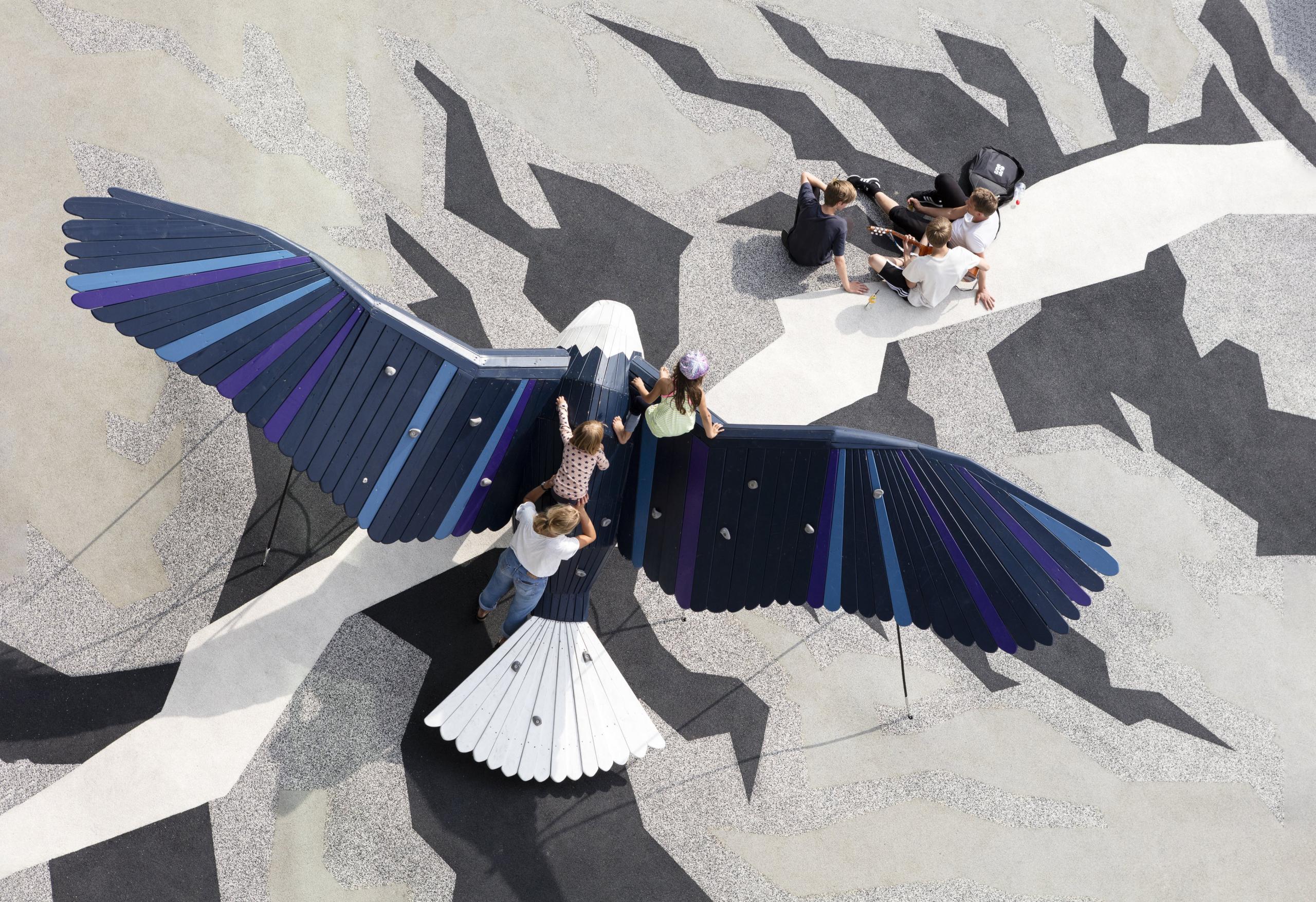 Kids and youths playing at eagle-shaped playground