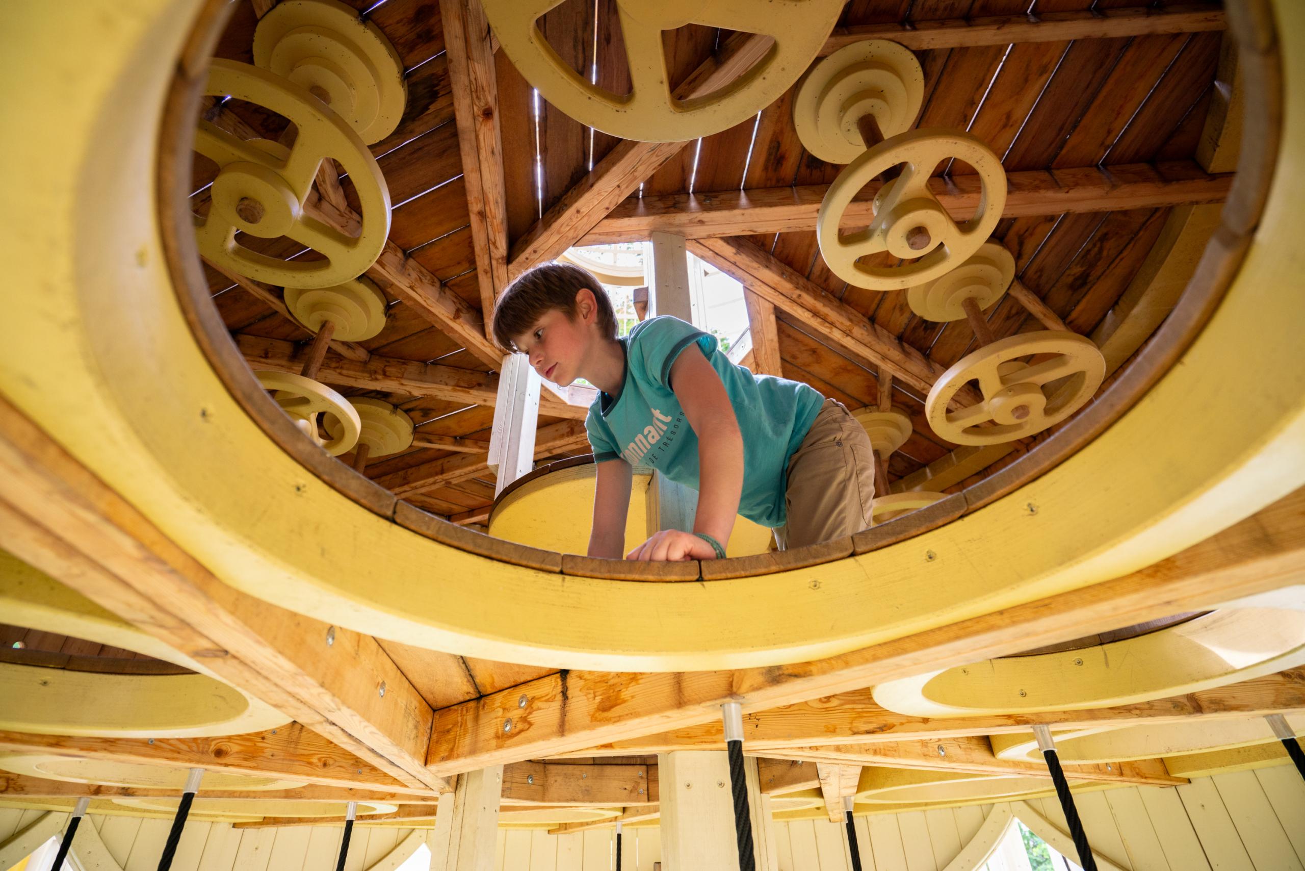 Boy playing in playground temple structure