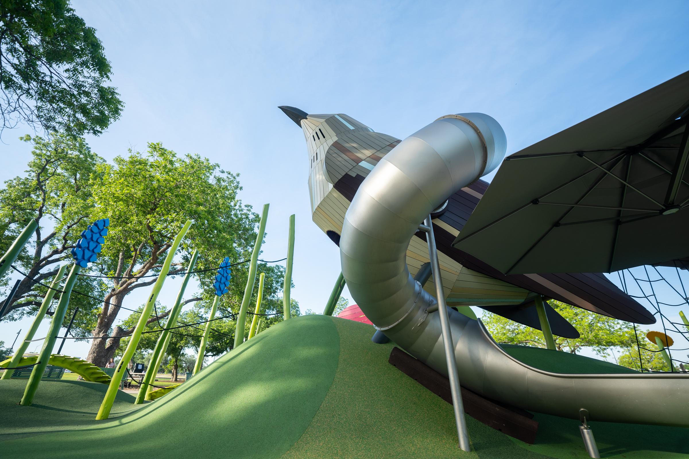 Frogs eye view of mockingbird with big tube slide at playground