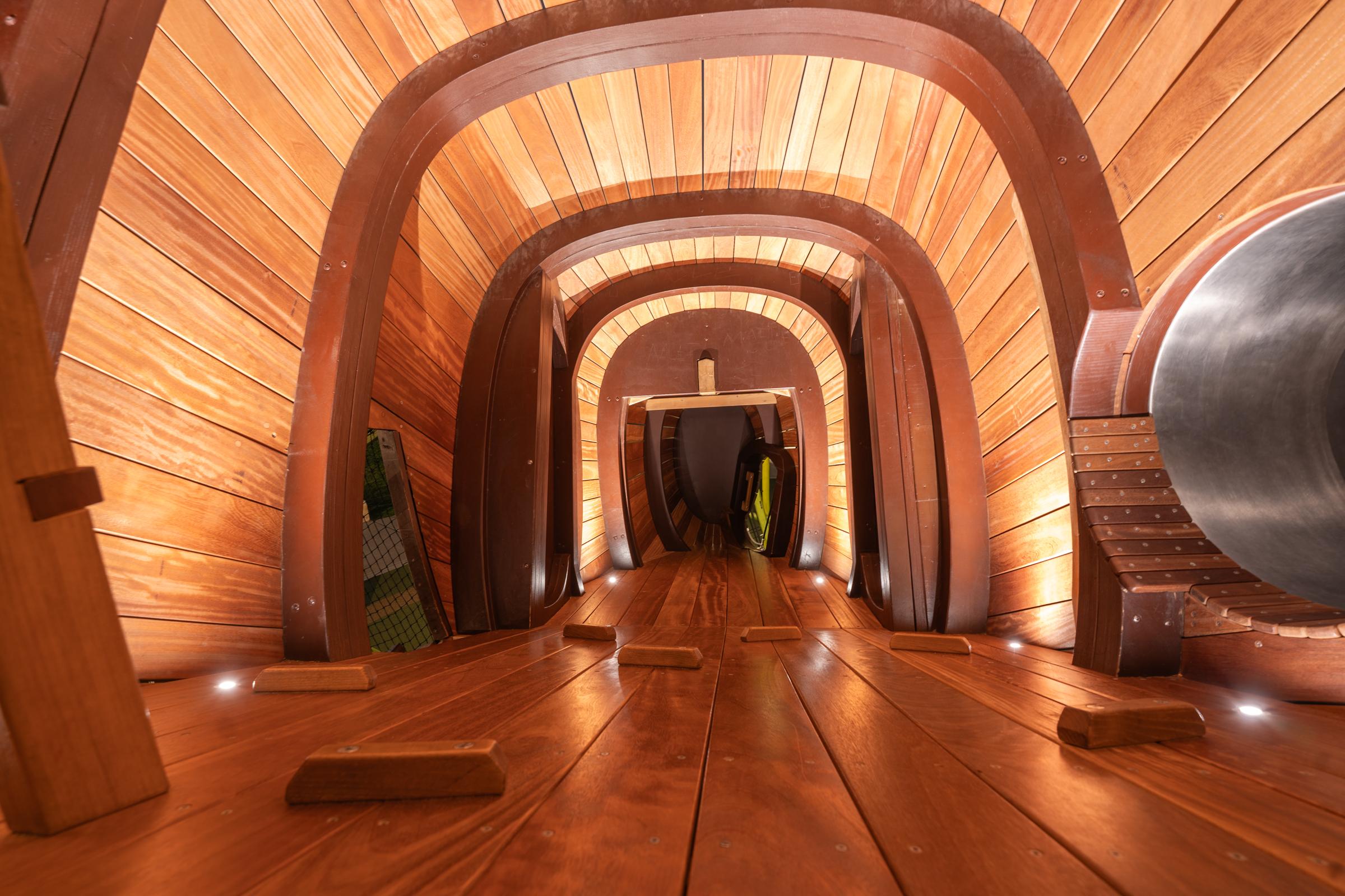Inside details of wooden mockingbird playground illuminated at night at Cedar Park Library