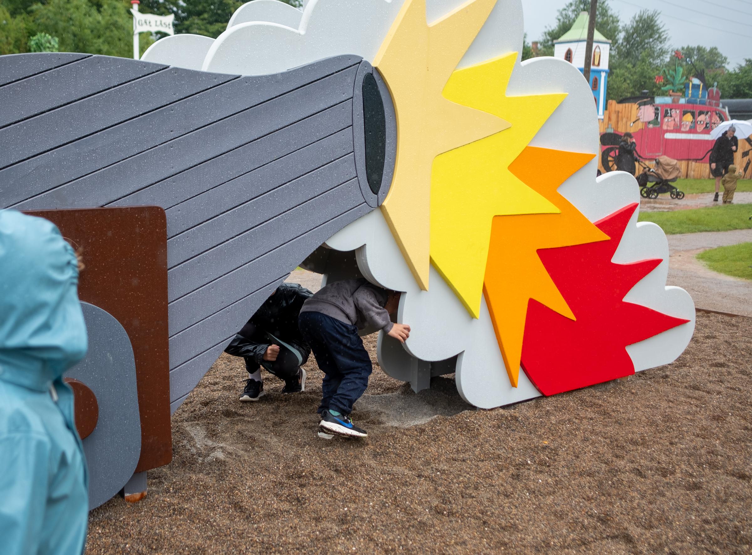 Kids playing in canon playground structure