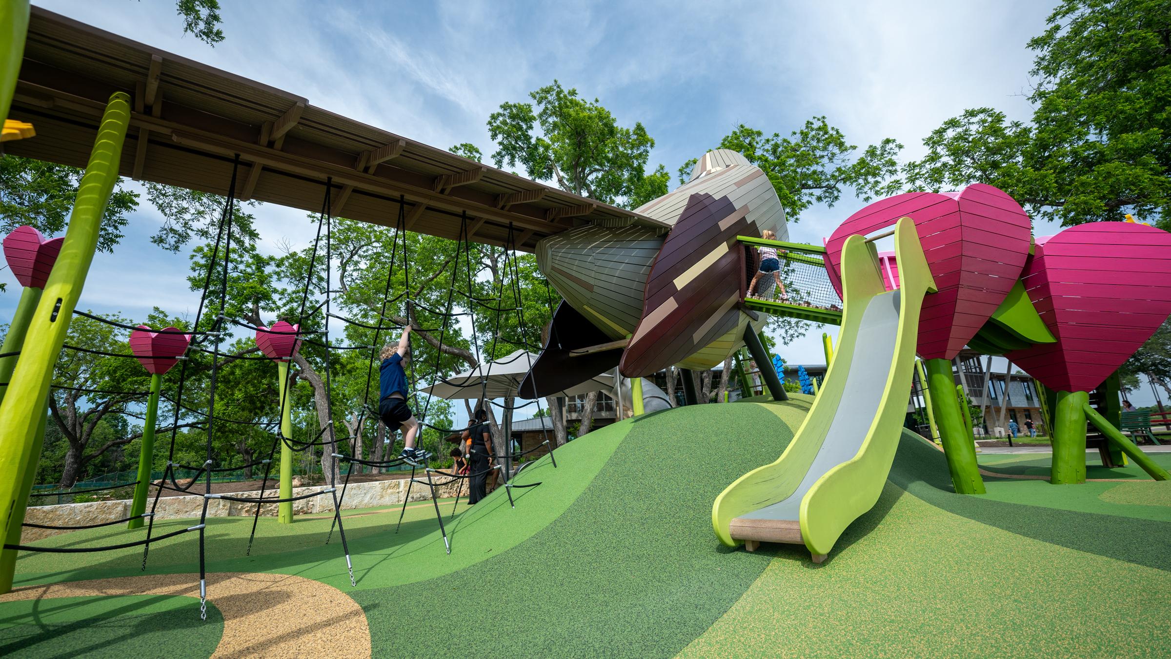 Kids playing under tail at mockingbird playground