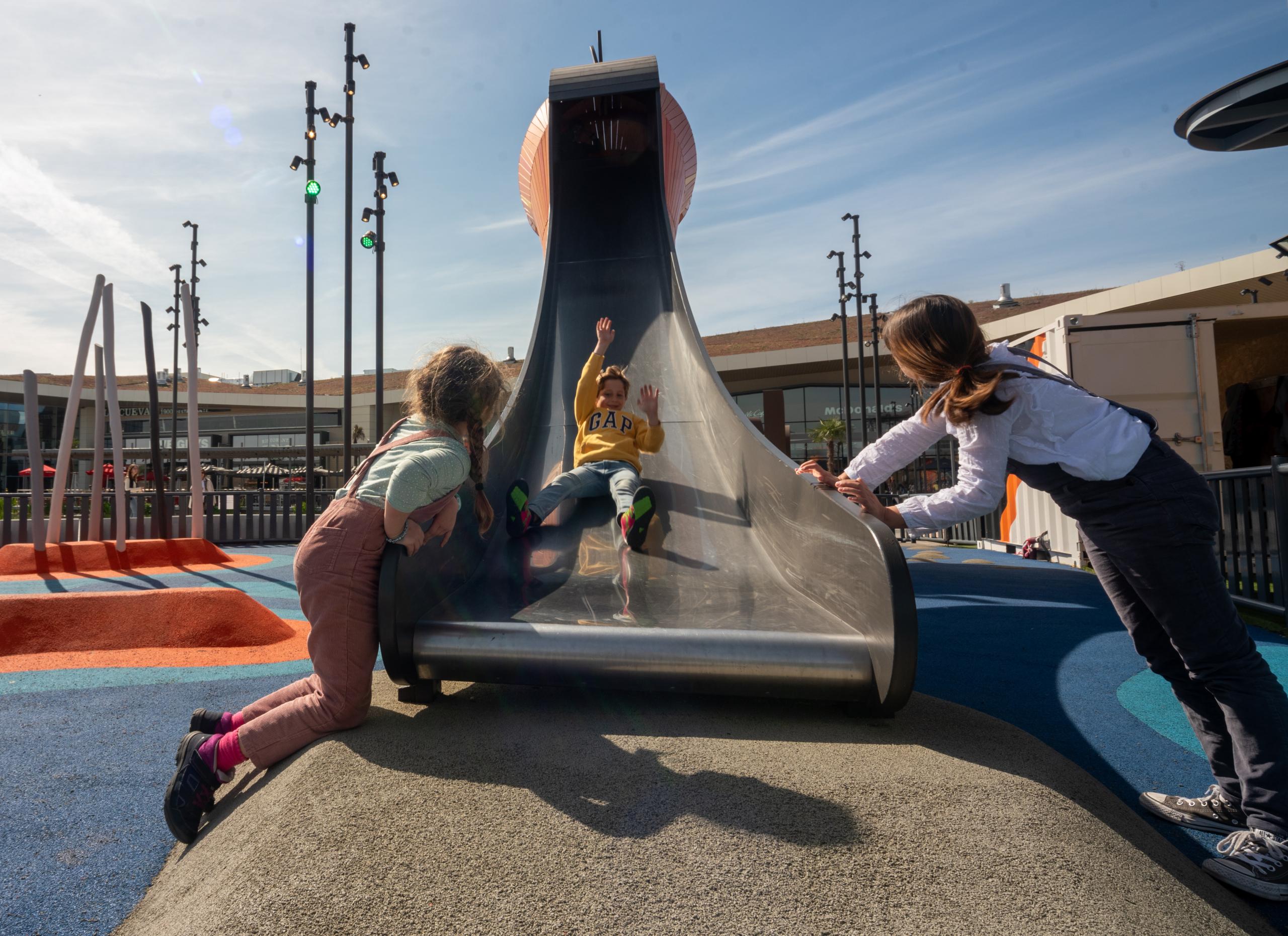 Boy sliding down playground slide