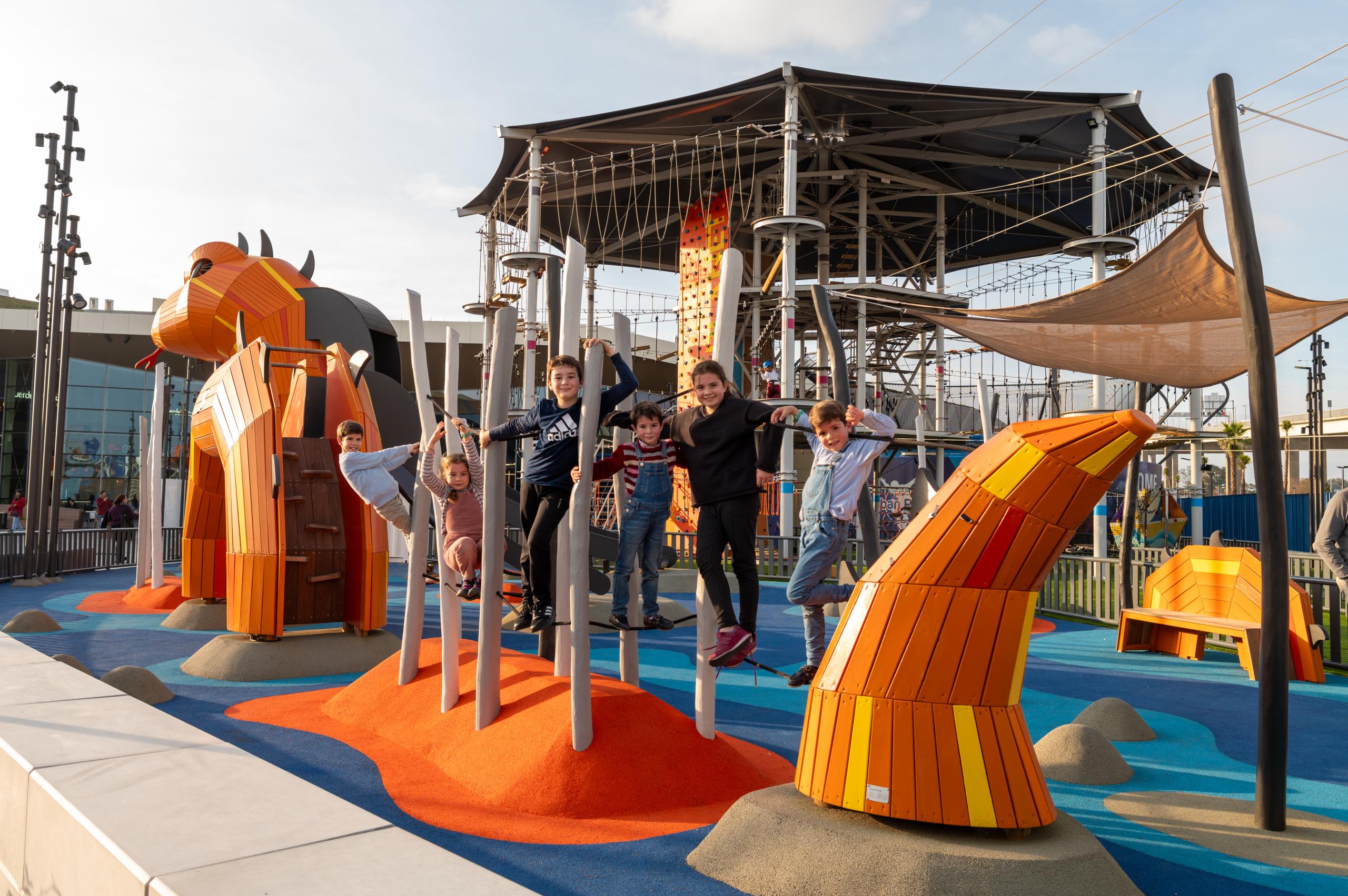 Children smiling at sea dragon playground