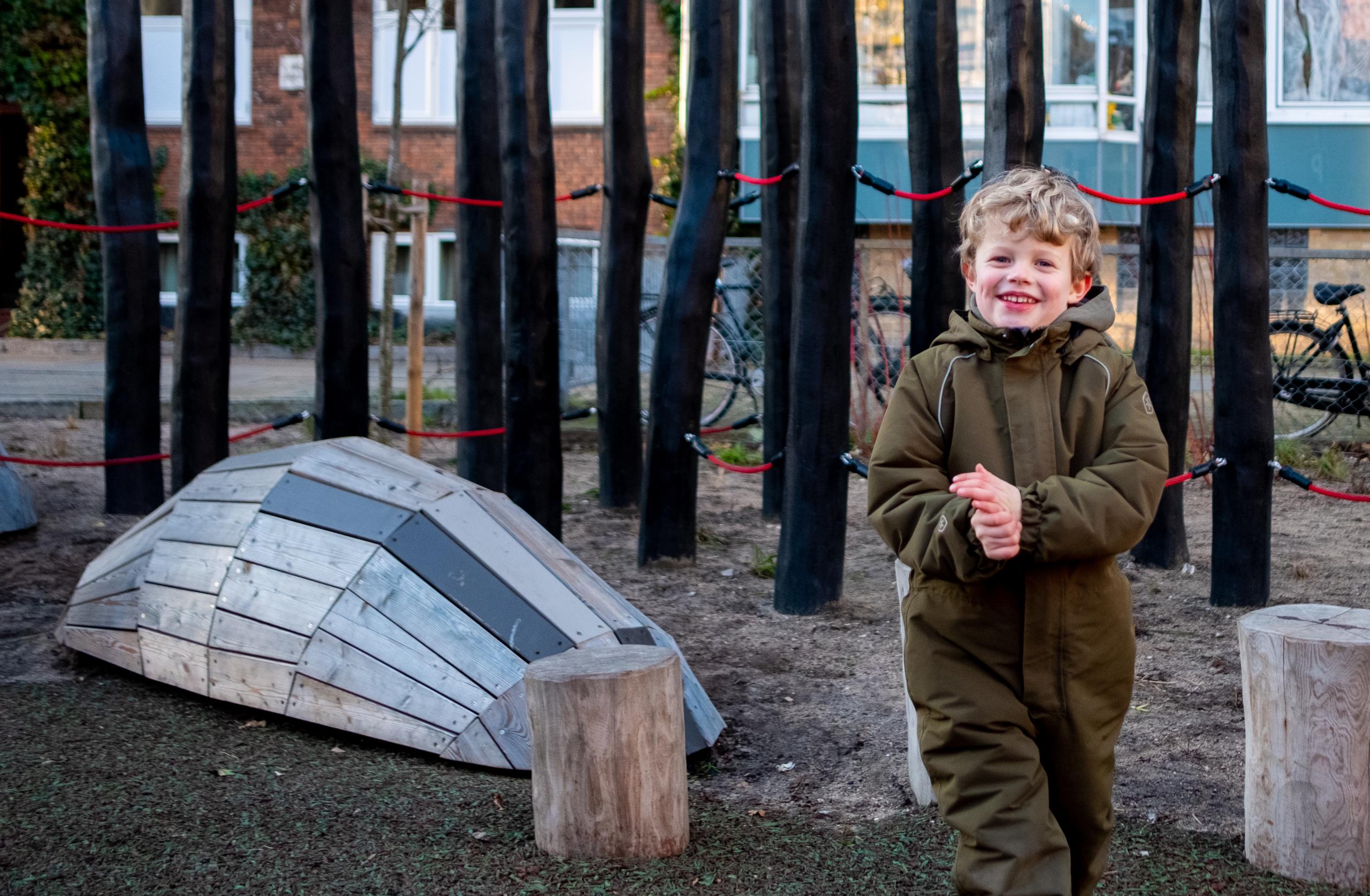 Happy boy playing at cobra playground