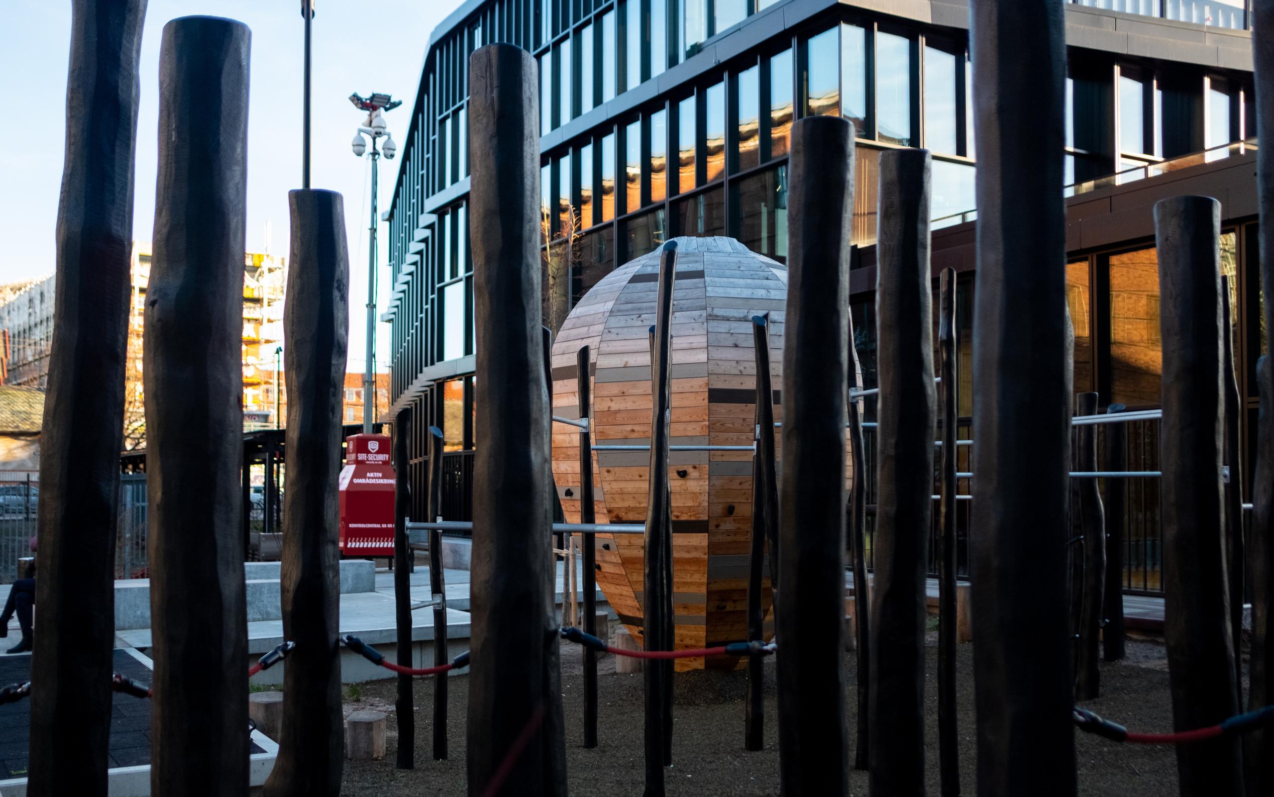 House of Martial arts building seen through a forest of wooden posts at cobra snake playground