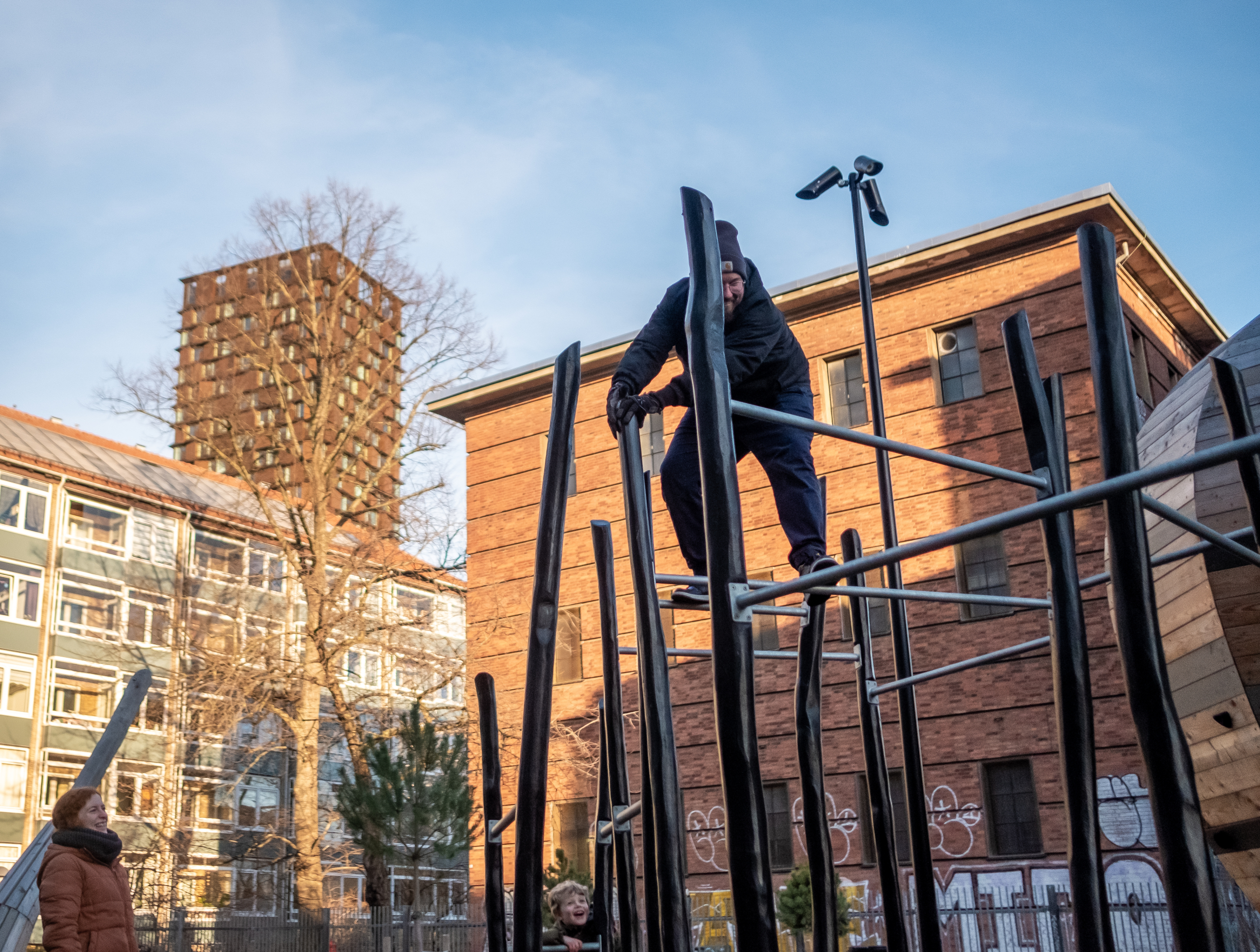 Man climbing parkour frame at cobra snake playground