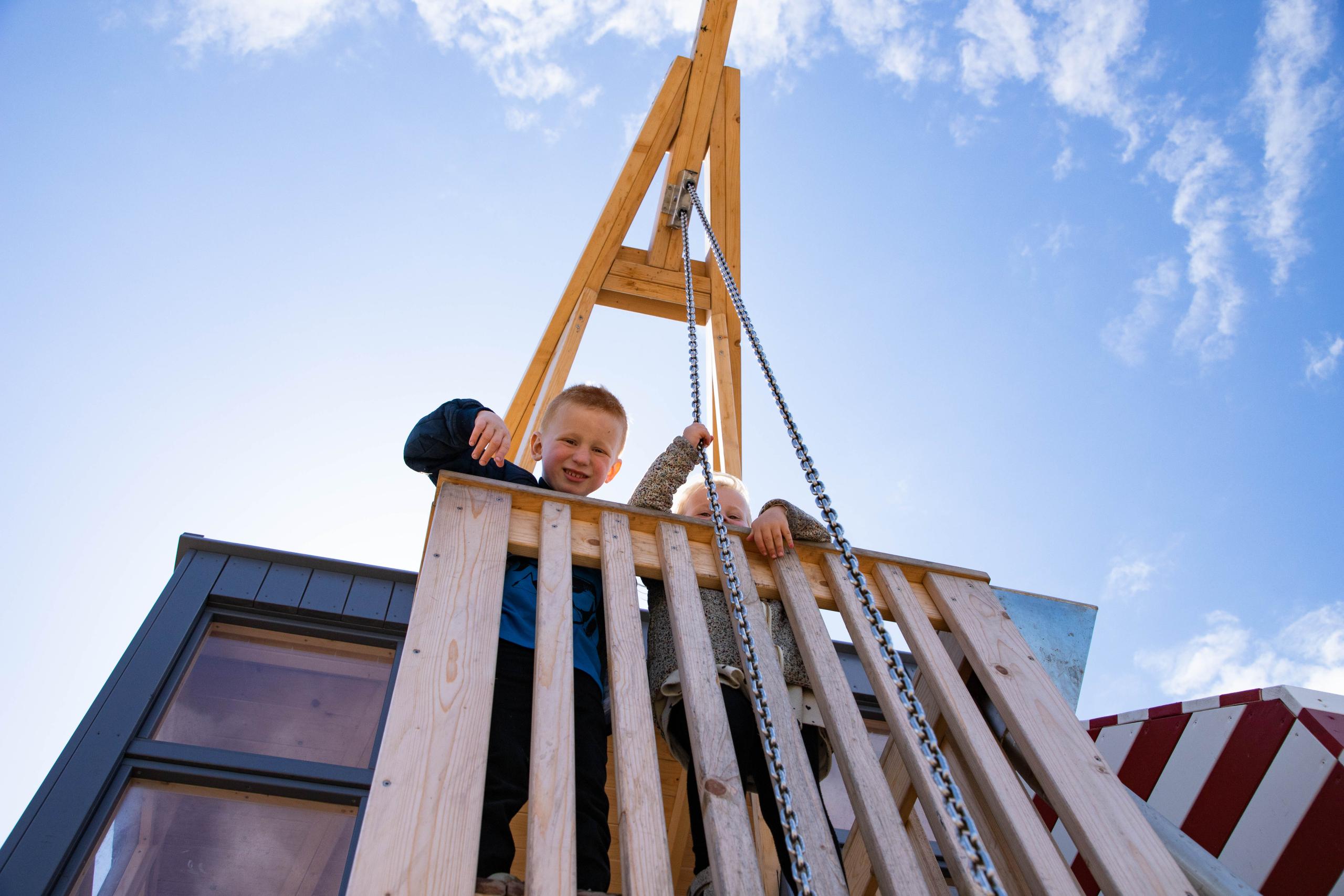 Kids playing in tower with sand crane