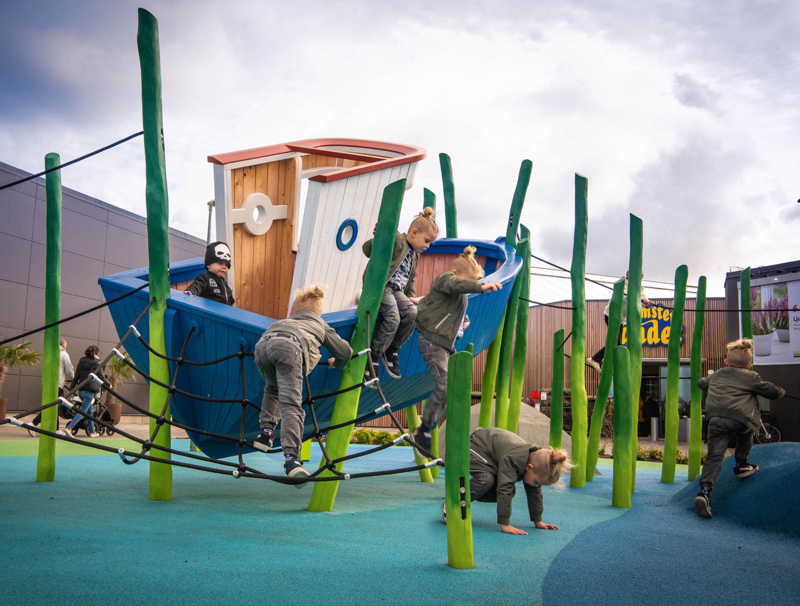 Boy jumping from fishing boat at MONSTRUM playground