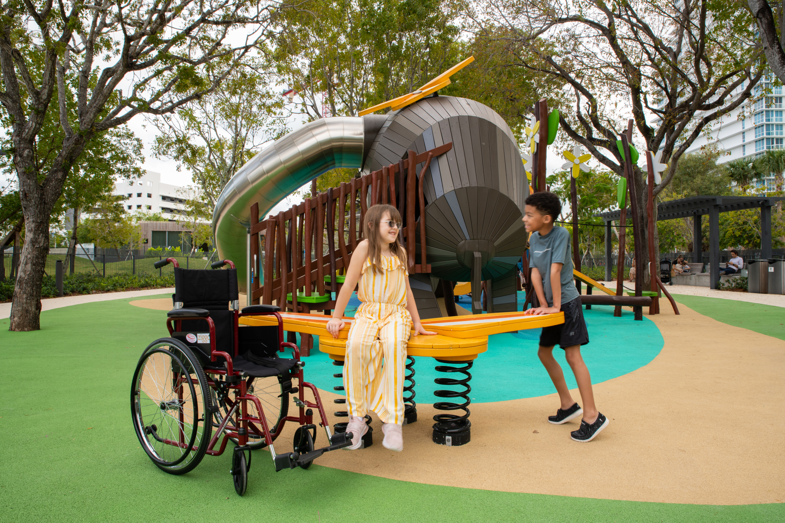 Girl playing at accessible MONSTRUM playground with her friend