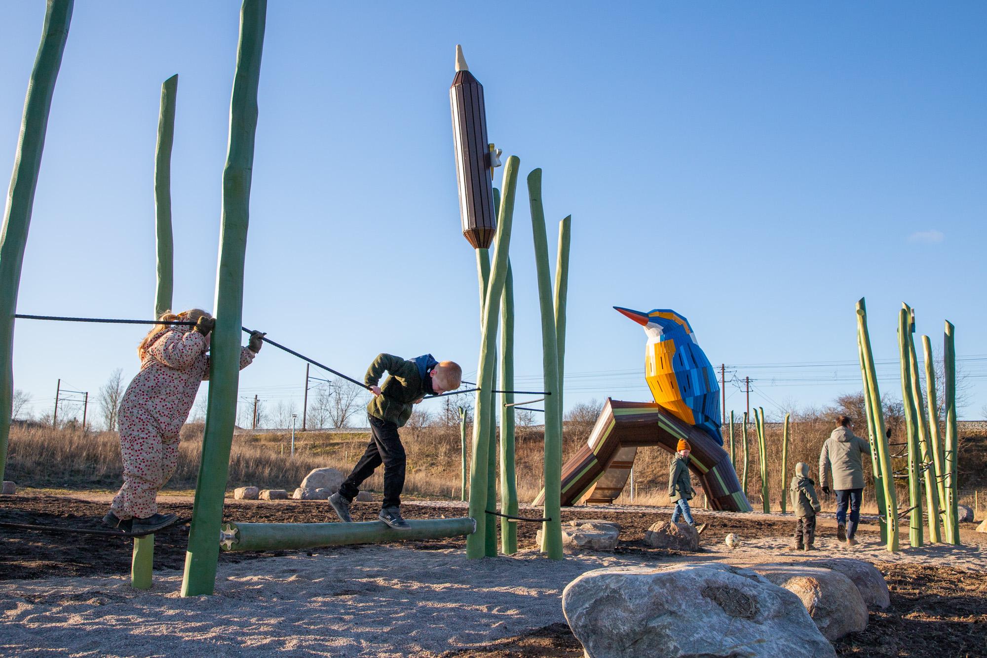 Kids playing on obstacle course at Kingfisher playground