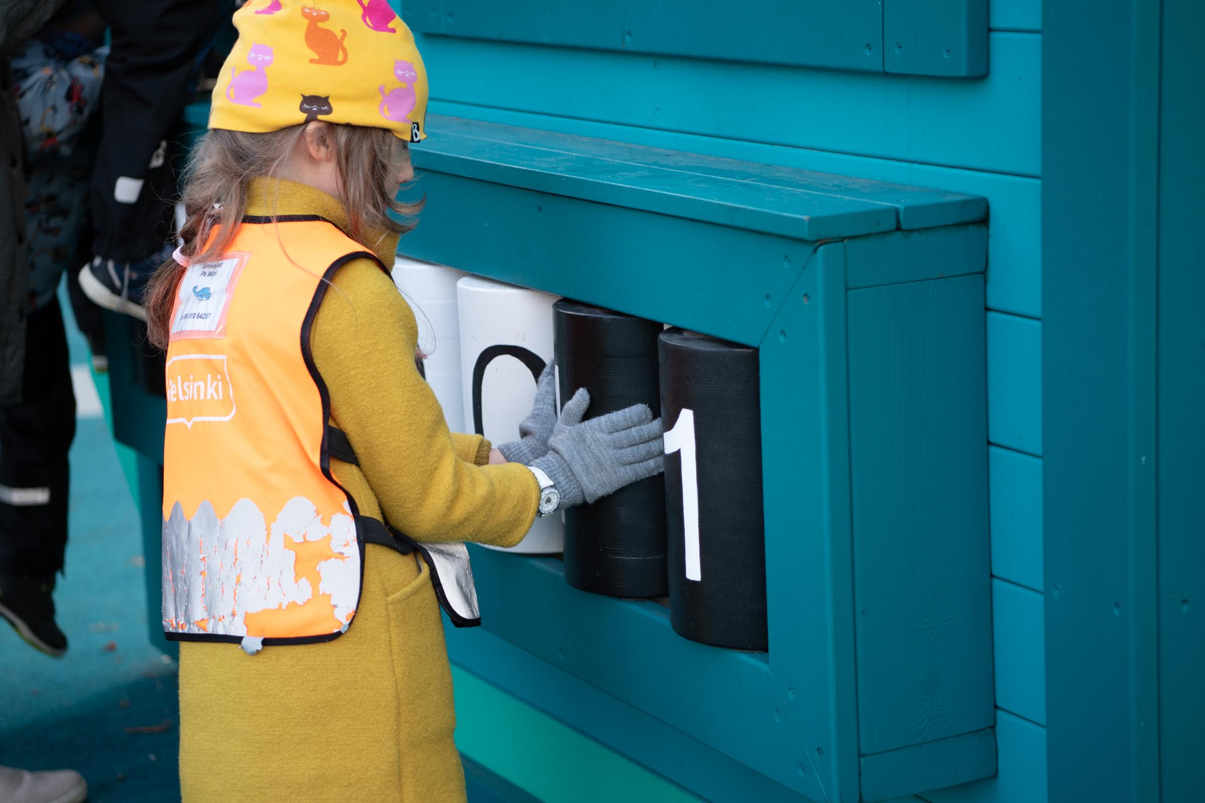Kid playing with binary play feature at playground