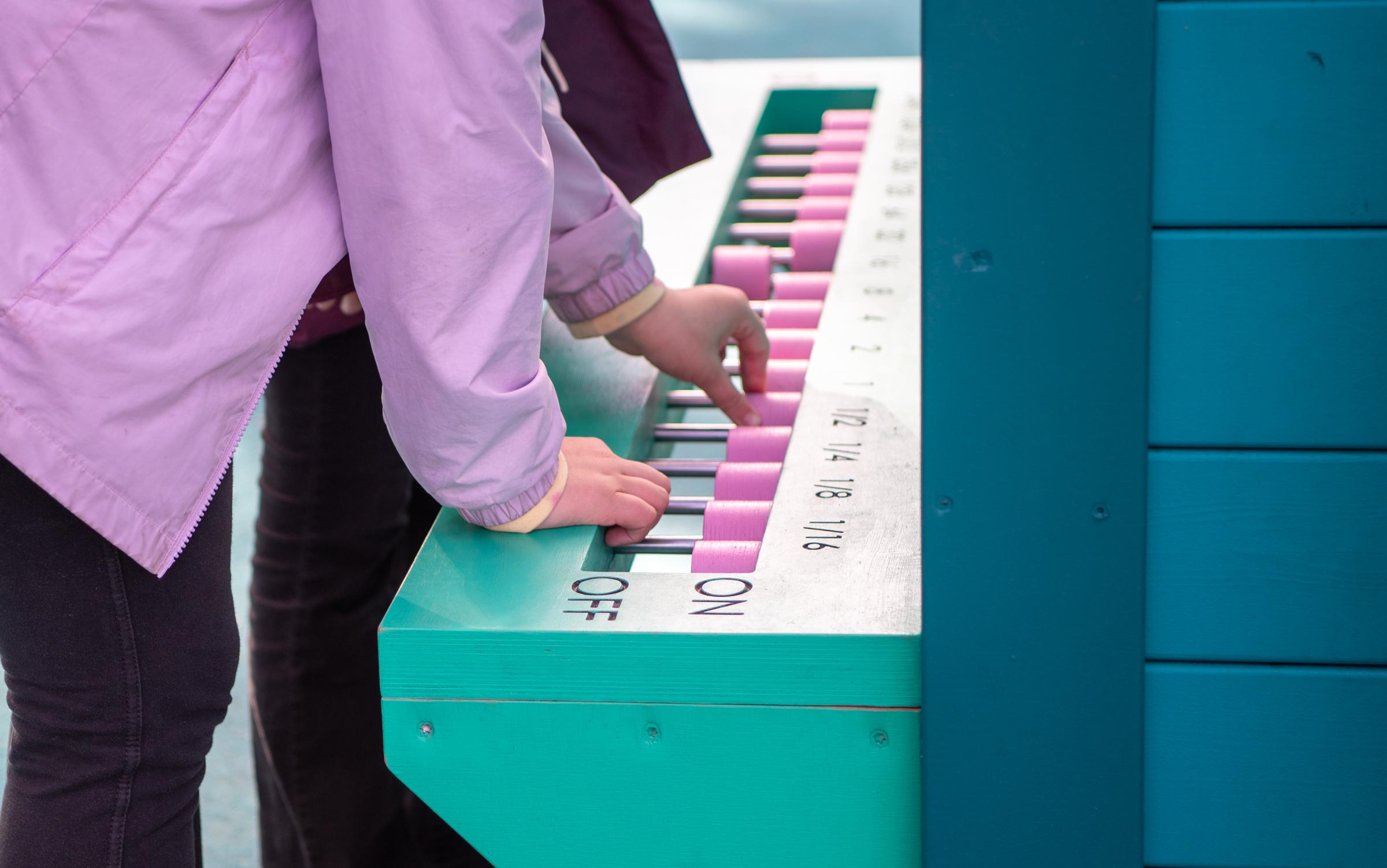 Kids playing with computer-themed playground feature