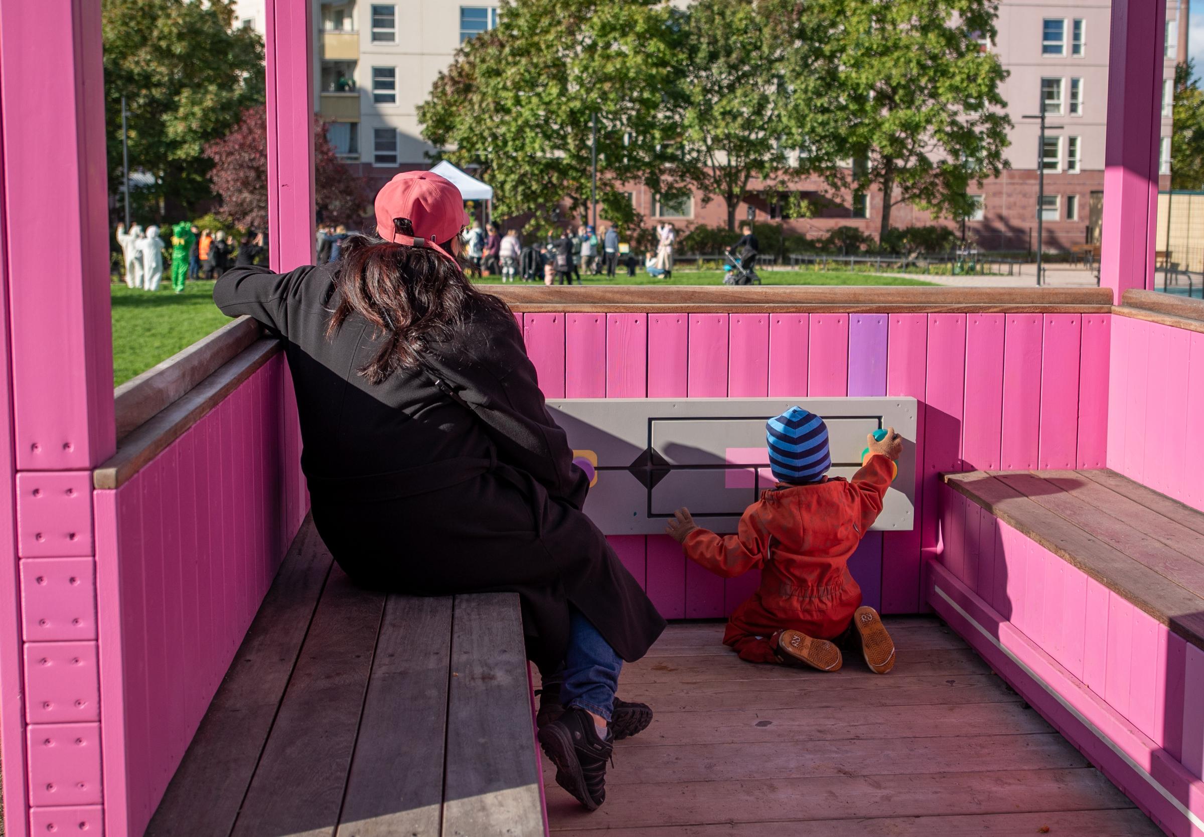 Mother and child sitting in playground structure