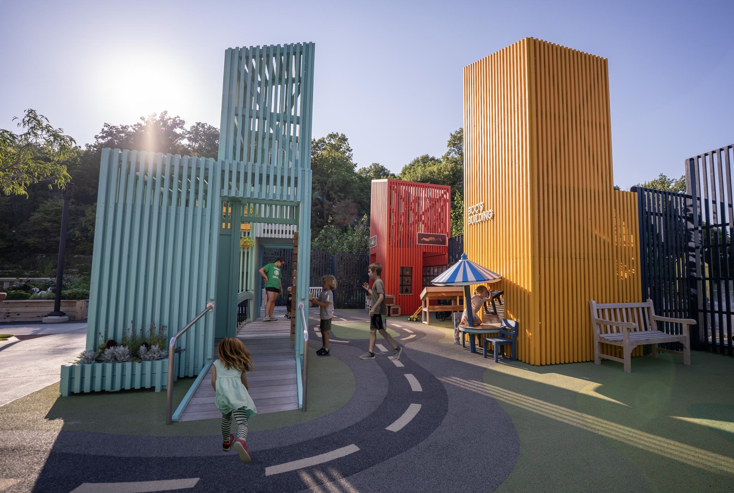 Wide view of colourful playground towers where children are playing