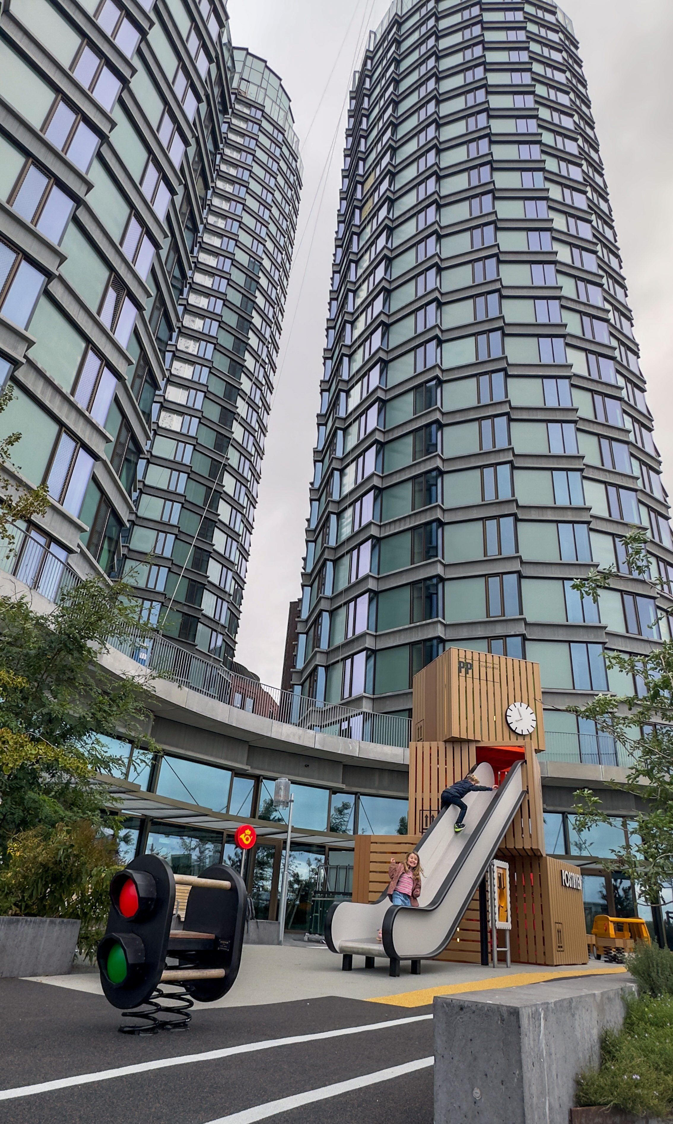 Playground towers beside huge architectural towers