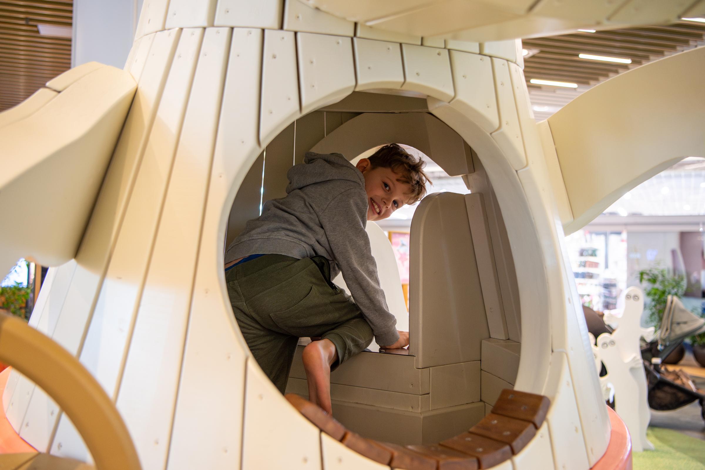 Boy about to slide down playground slide