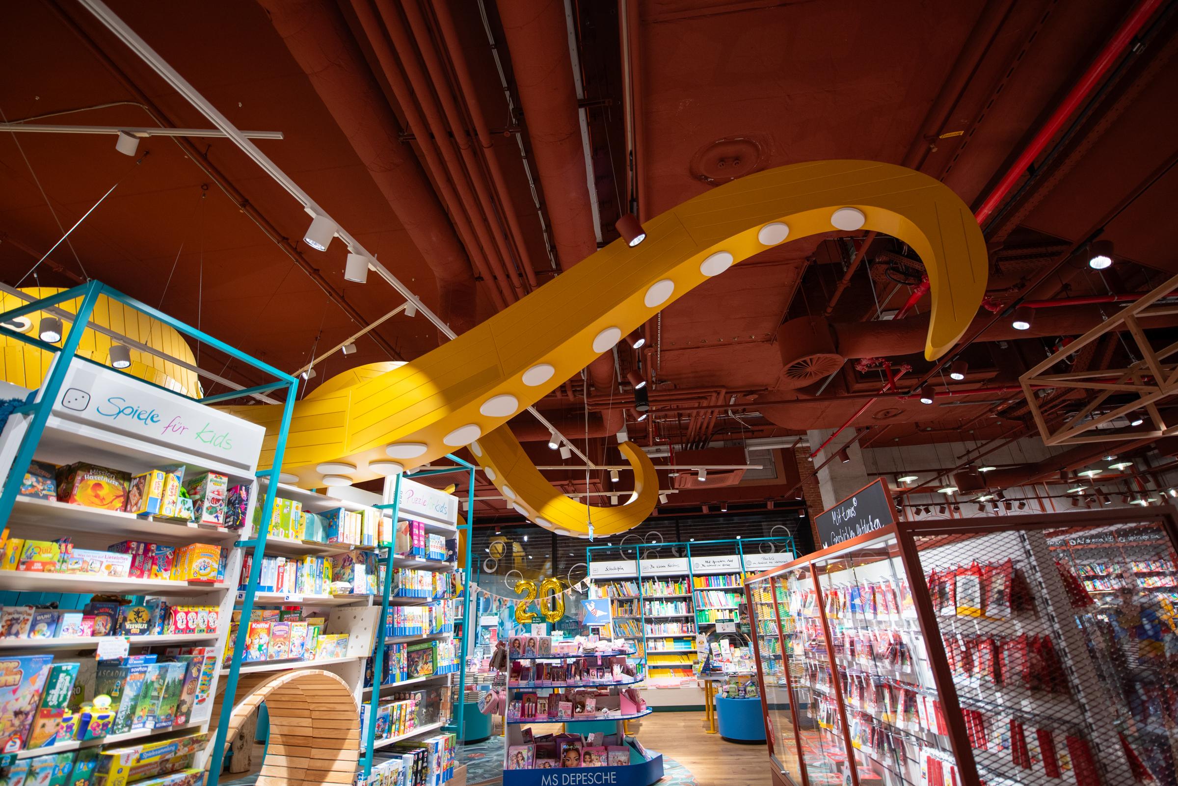 Octopus arm sticking through bookshelf in bookshop