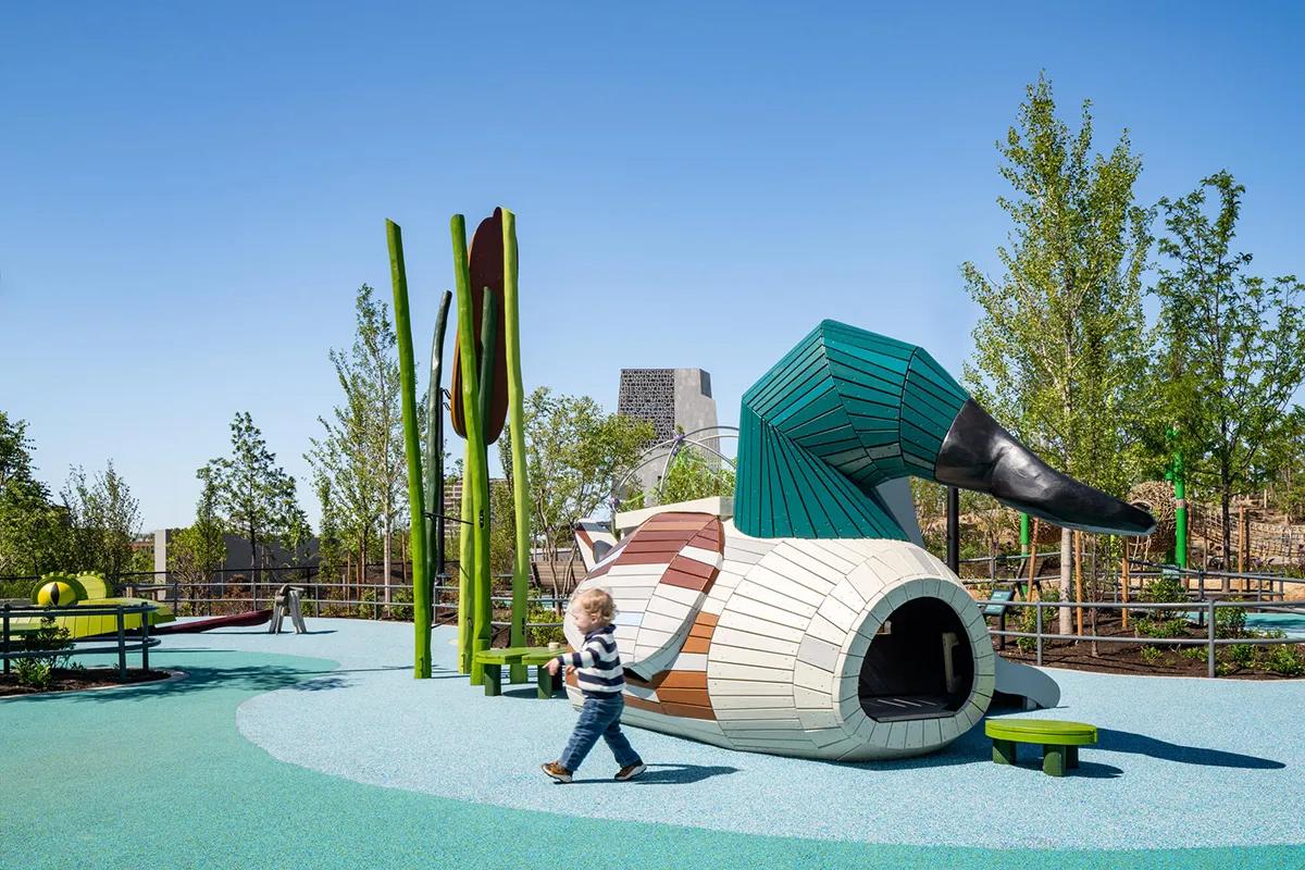 Boy playing next to duck playground structure at Obama Presidential Center