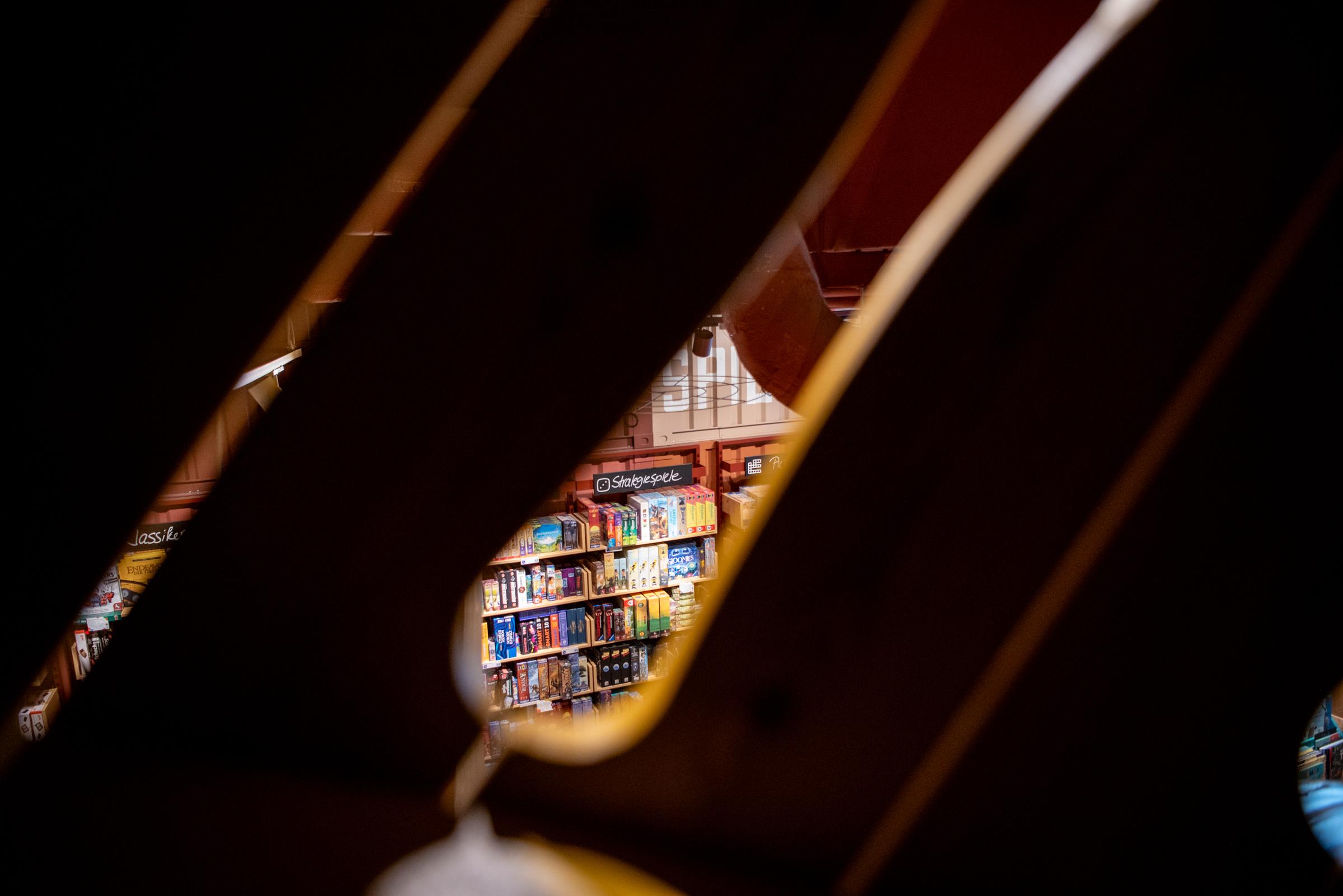 books seen through opening in wooden boards at playground