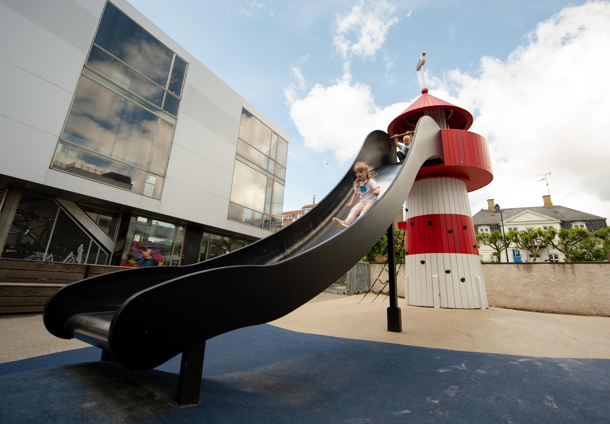 Girl sliding down big slide