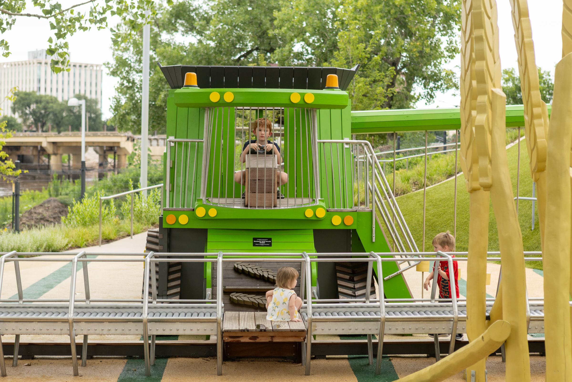 Kids playing on playground combine harvester