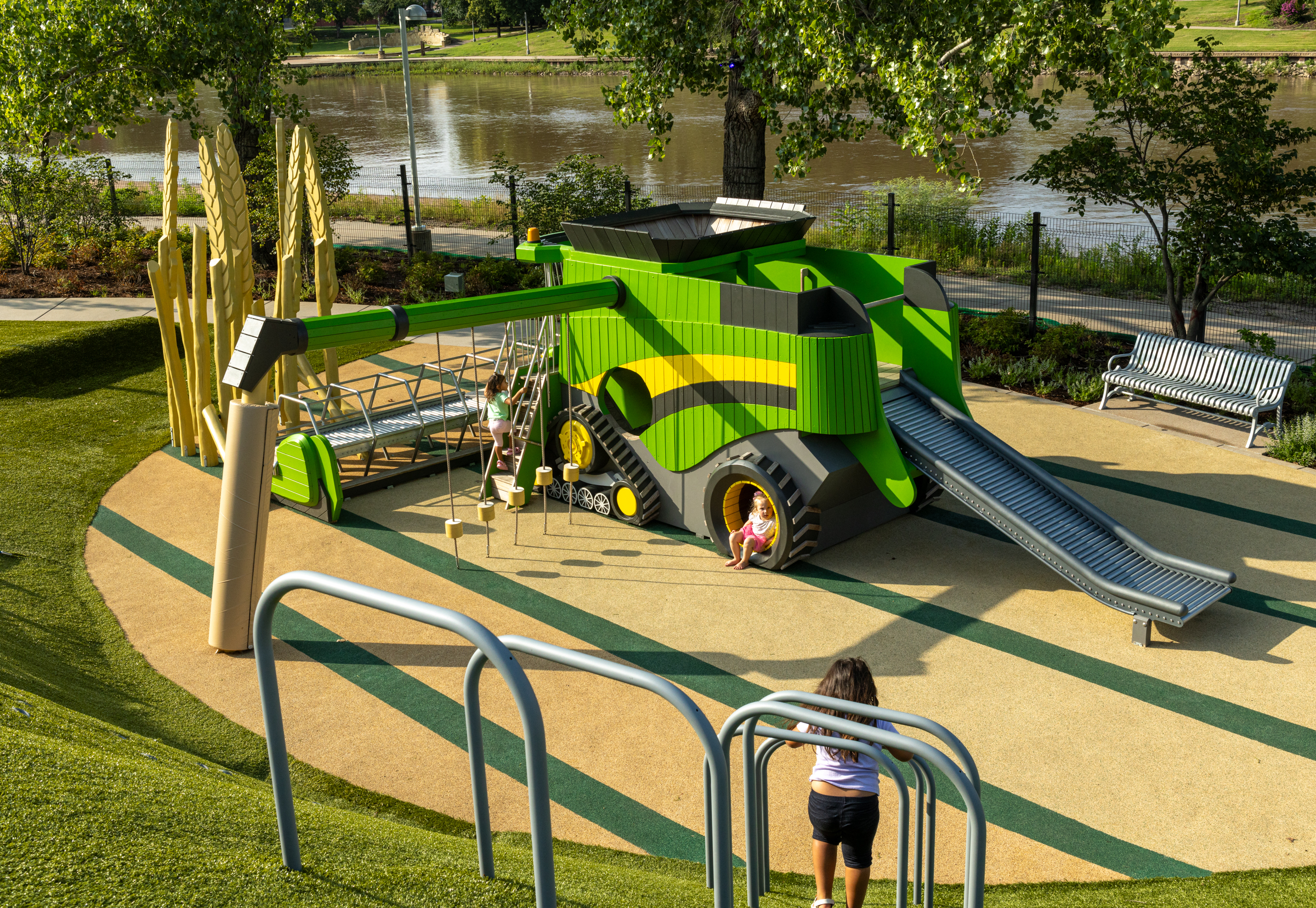Kids playing at wooden playground combine harvester