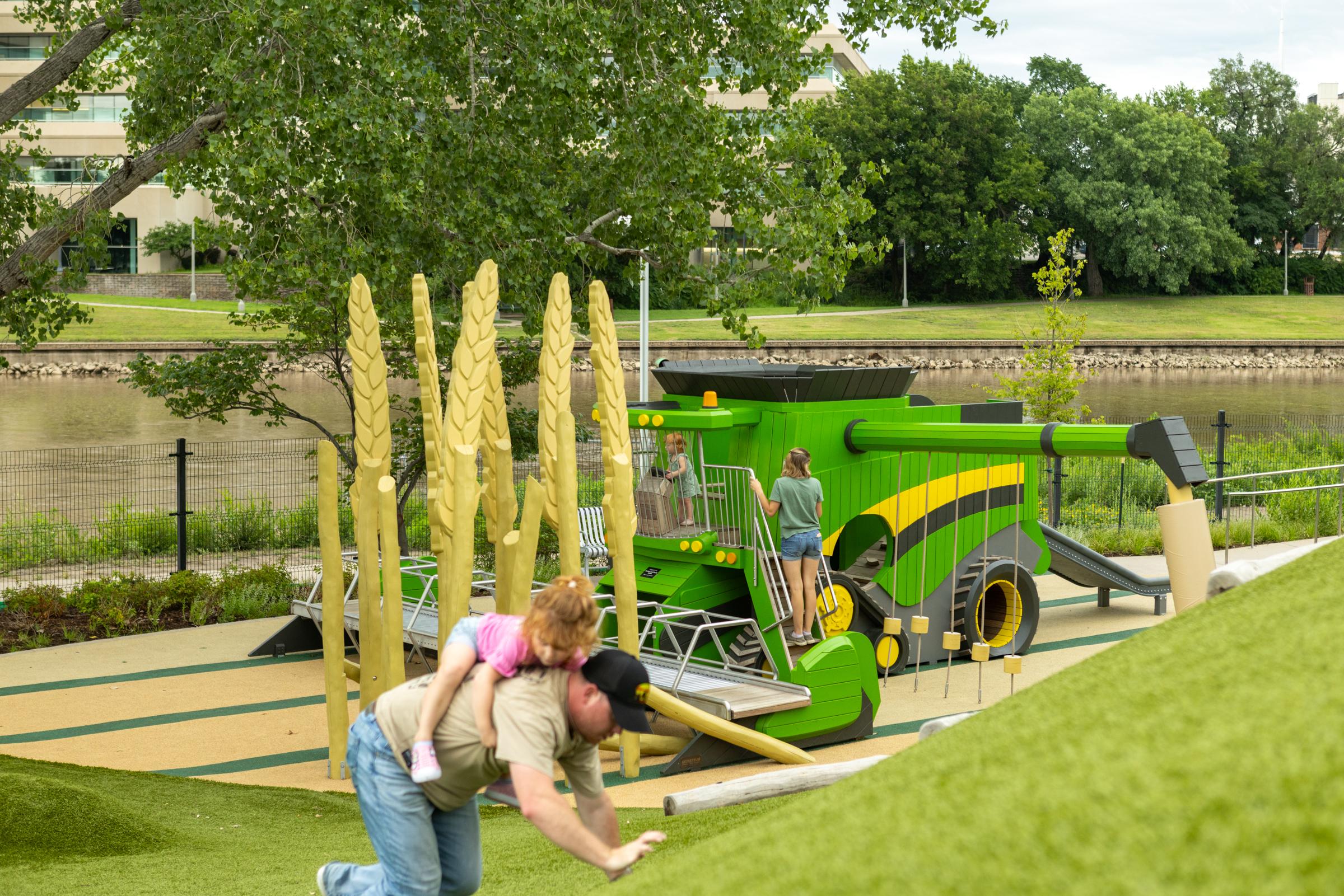Parents and children playing at combine harvester play area