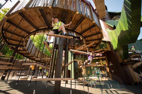 Boy climbing at climbing frame at Lilidorei playground