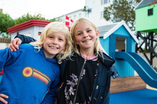 Children standing together and smiling at playground