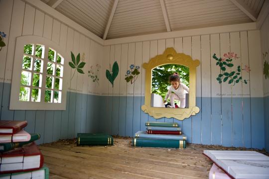 Girl climbing into playground house