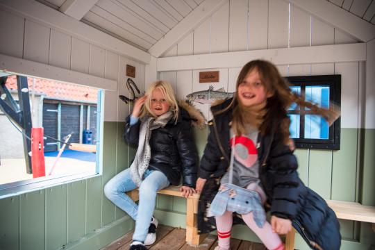 Girls in play house at playground