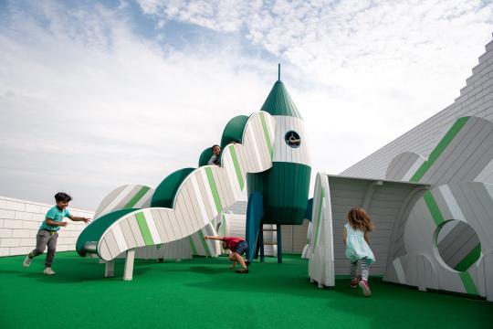 Kids playing at rocket themed plaground