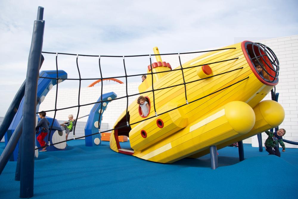 Children playing at submarine and sea monster playground, LEGO House