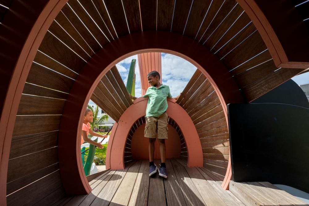 Boy standing in Flamingo playground structure